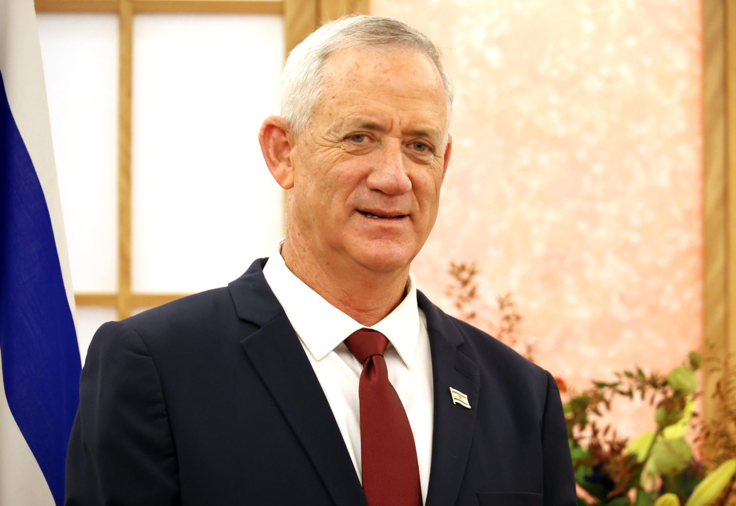 Benjamin Gantz stands near flag