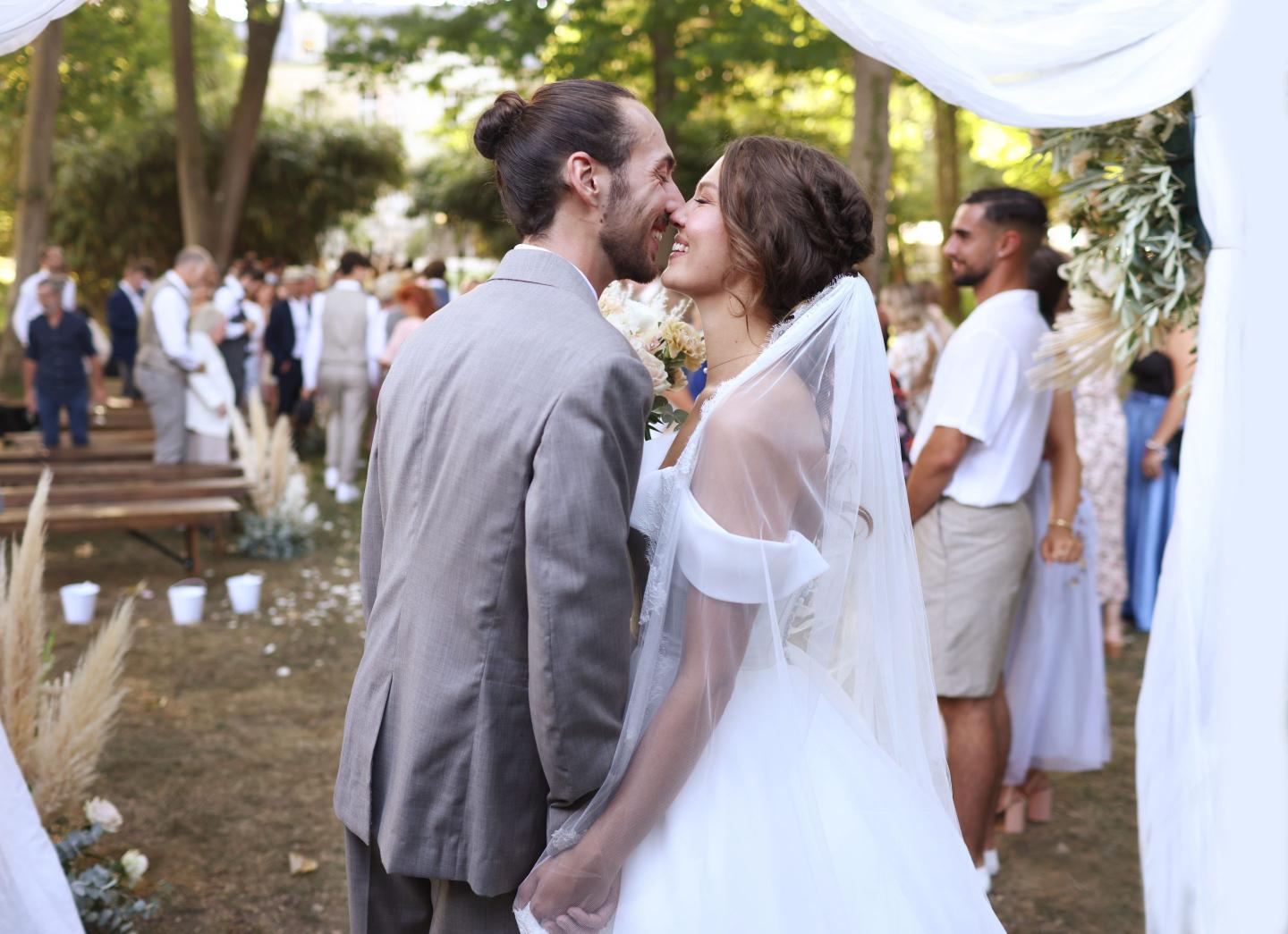 a bride and groom kissing at the alter of a wedding ceremony