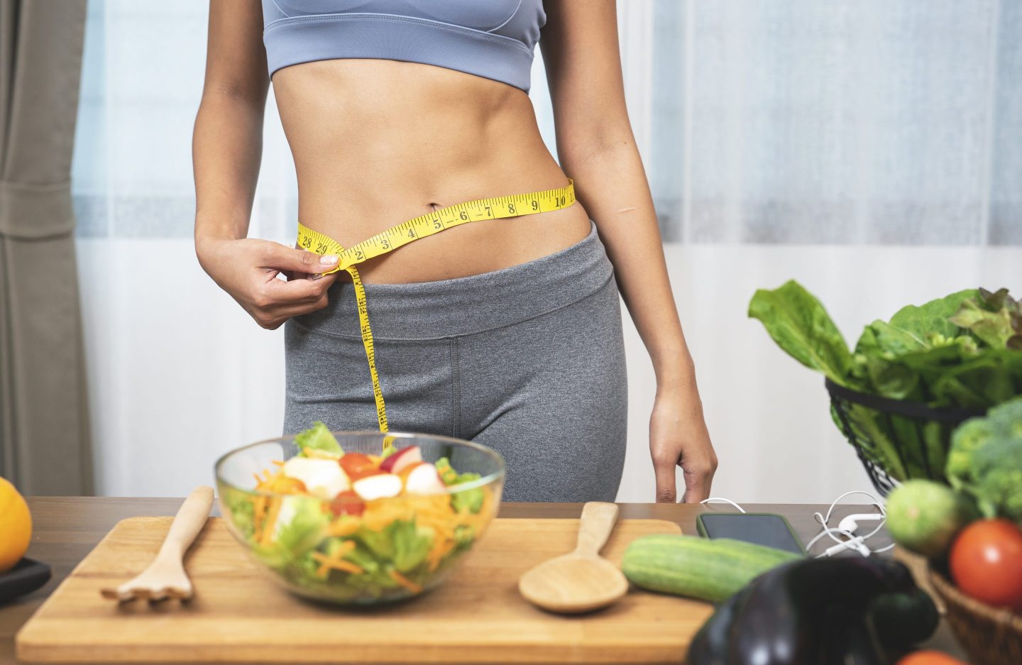 woman measures her waist