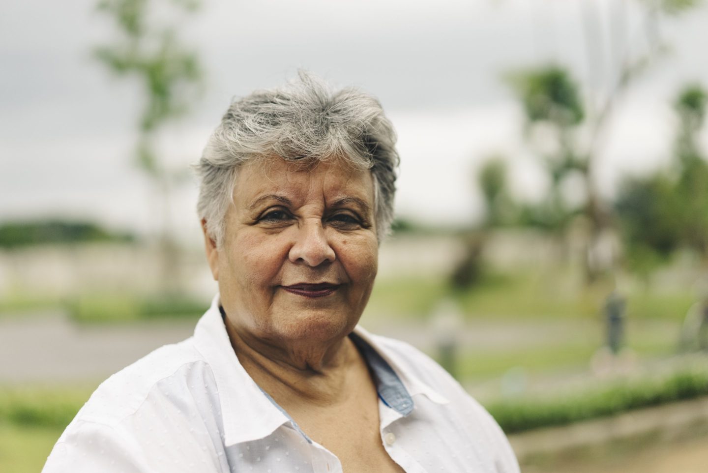 Portrait of Asian active senior with green background.