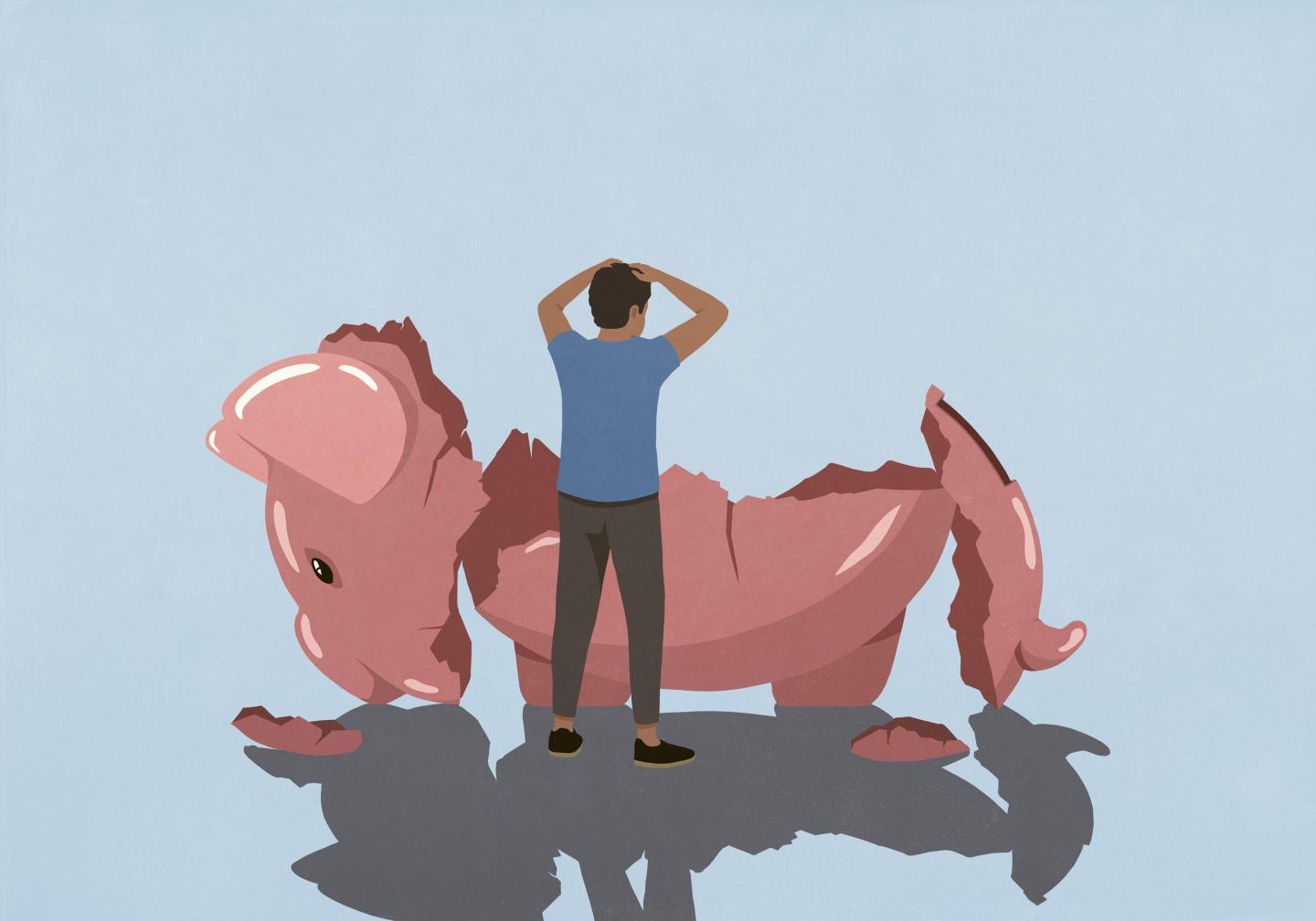 Image of a stressed looking man looking at a broken piggy bank