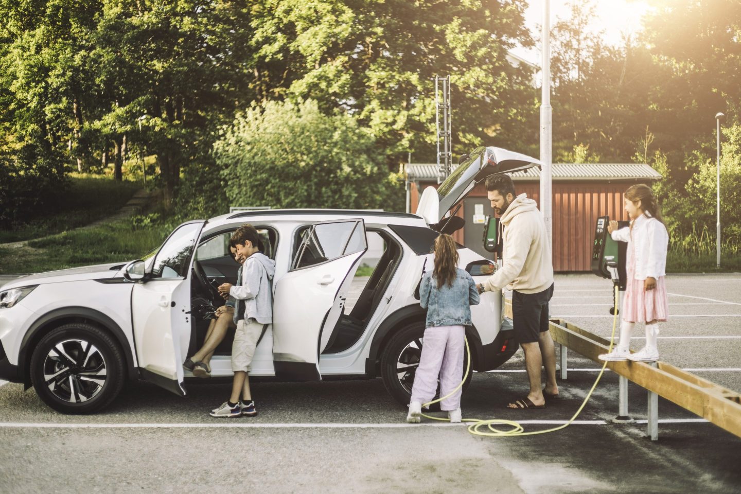 A family charging their electric vehicle.