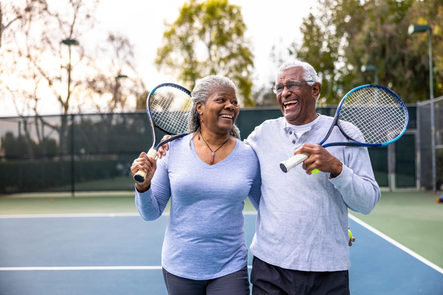 Senior Black Couple Walking Off the Tennis Court