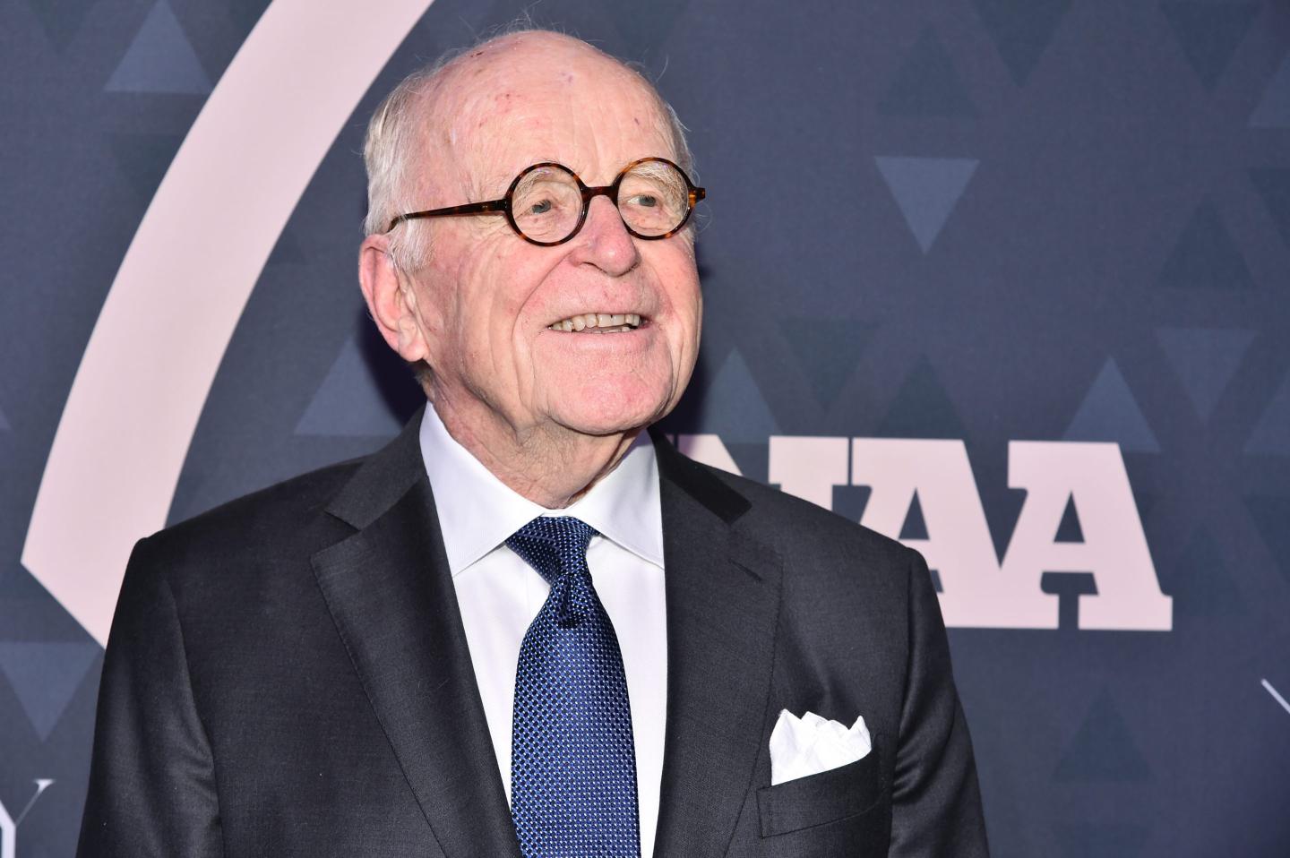 Bruce Nordstrom wears a suit and blue tie and smiles while looking slightly to his left.