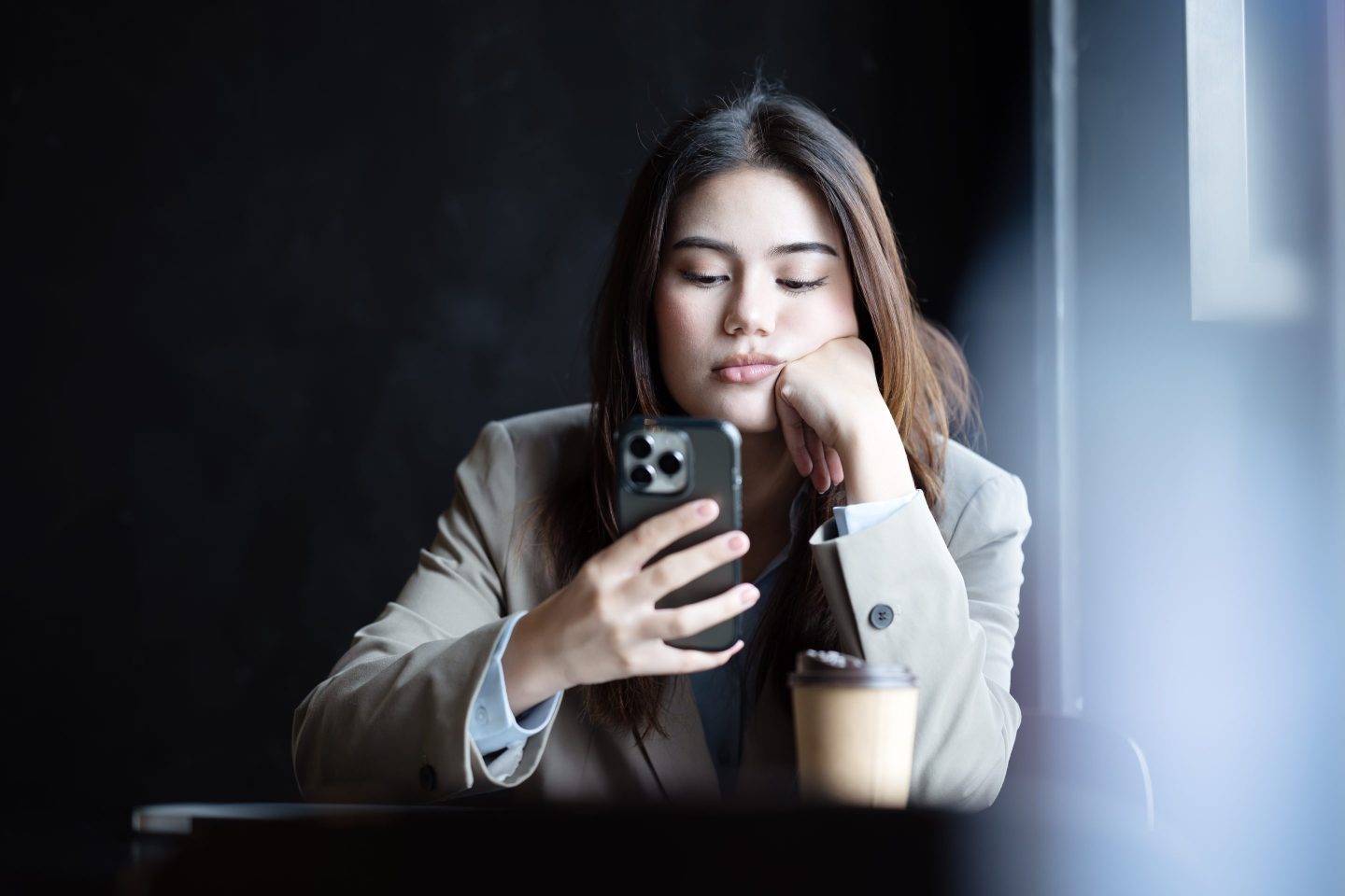 Disappointed young woman reading something on her phone