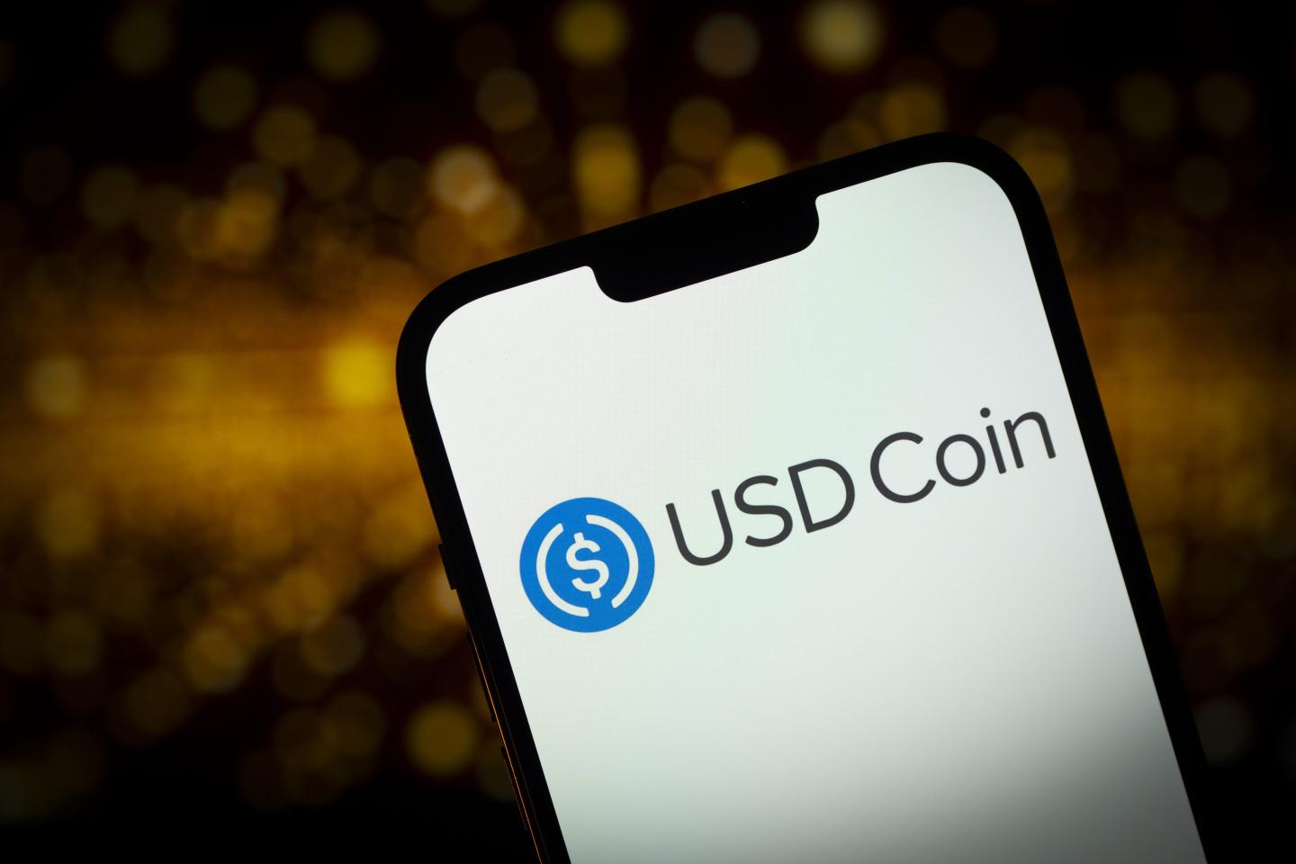 USD Coin logo on a phone