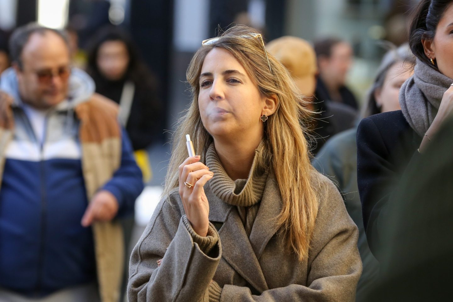 A woman smokes an e cigarette in Oxford Street in central London.