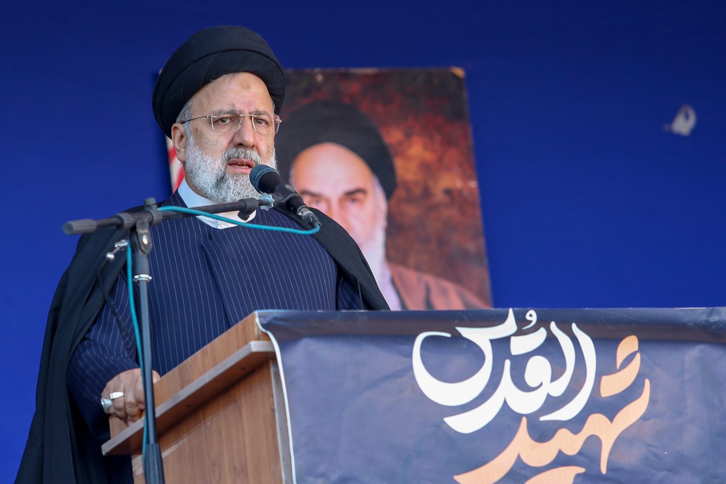 Iranian President Ebrahim Raisi speaks at podium