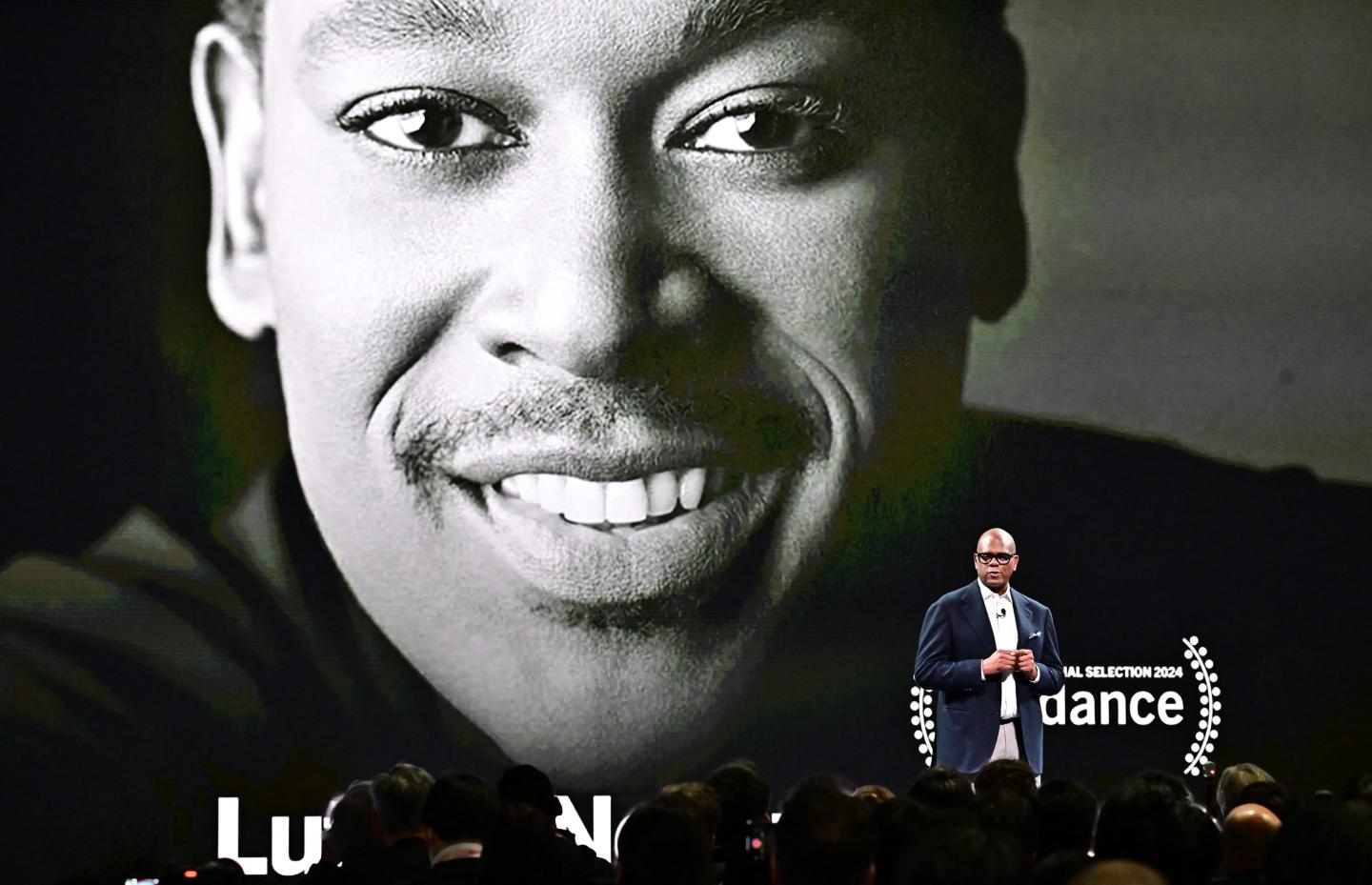 Jon Platt speaks in front of a poster