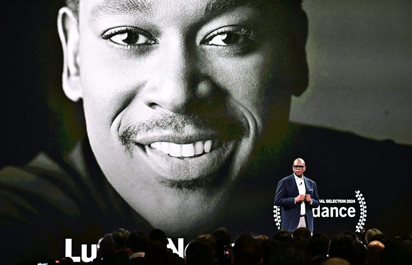 Jon Platt speaks in front of a poster