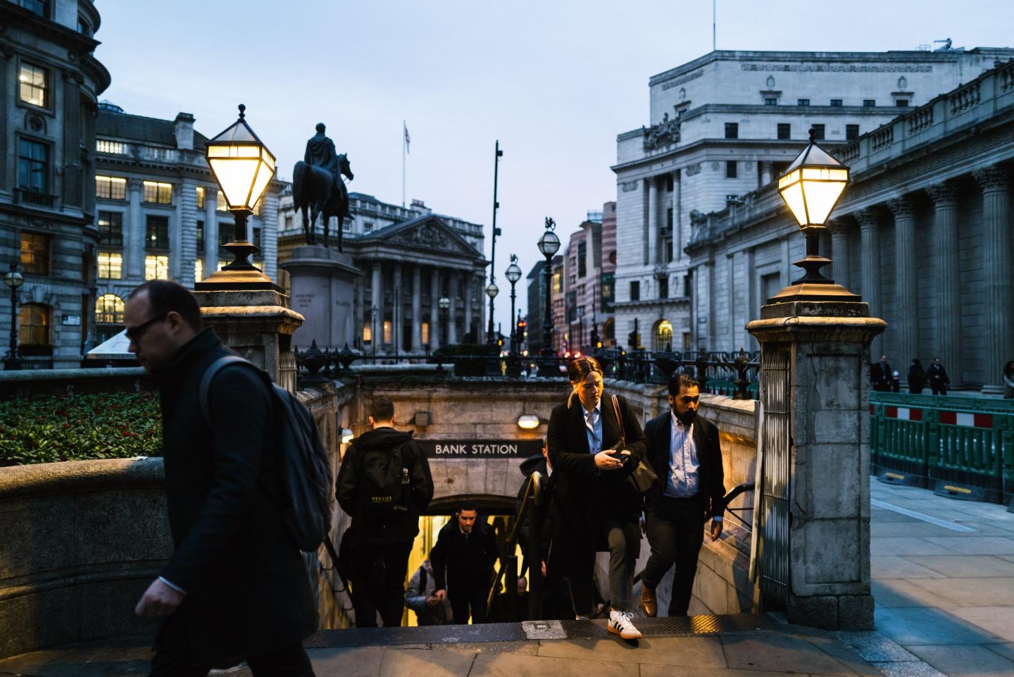 people moving in and out of a tube station