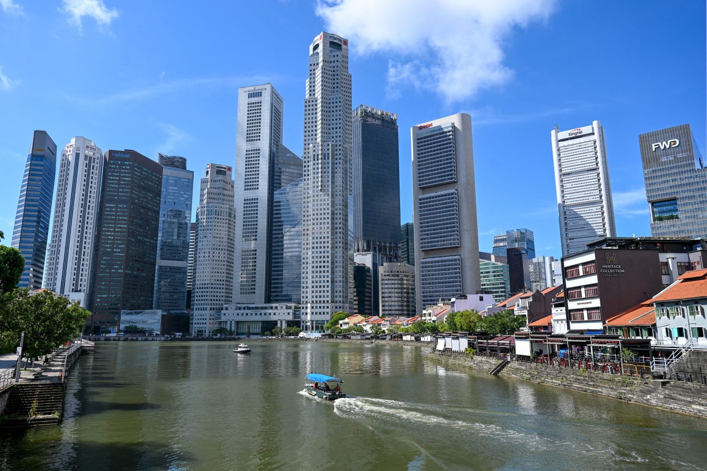 A boat cruises on the water in Singapore's central financial business district. The city-state has remained an attractive destination for private equity investments.