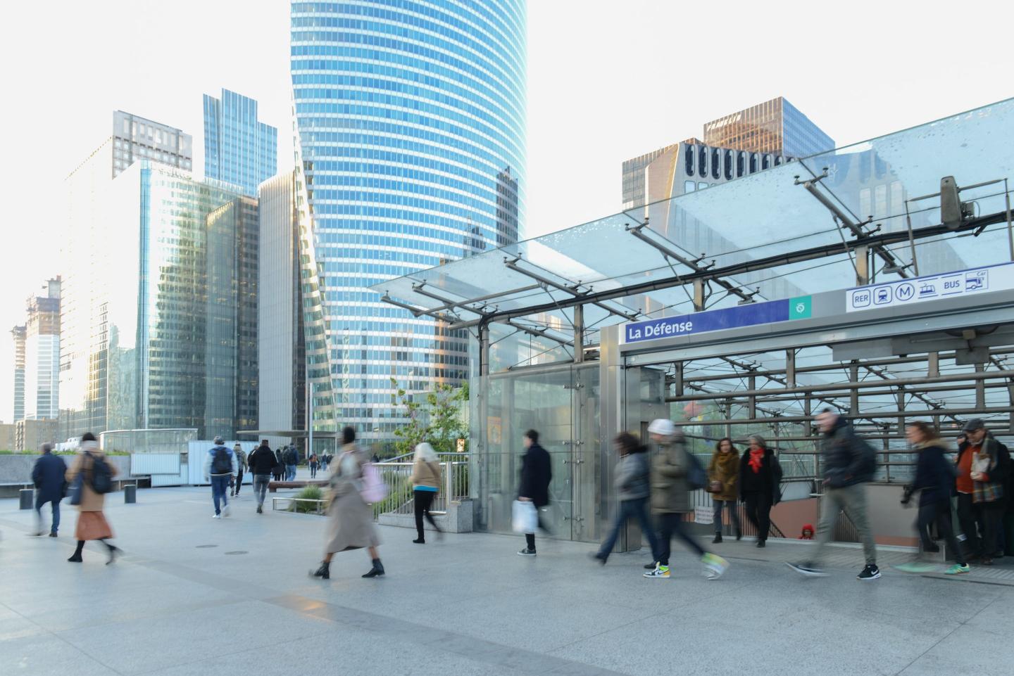 people walking outside La Defense area in Paris