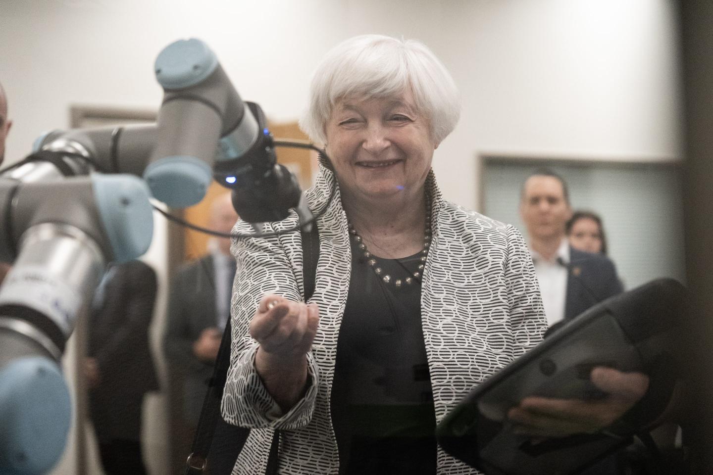 U.S. Treasury Secretary Janet Yellen interacts with a robotic arm during a tour of the Mesa Community College automation and engineering labs in Mesa, Arizona on May 4.
