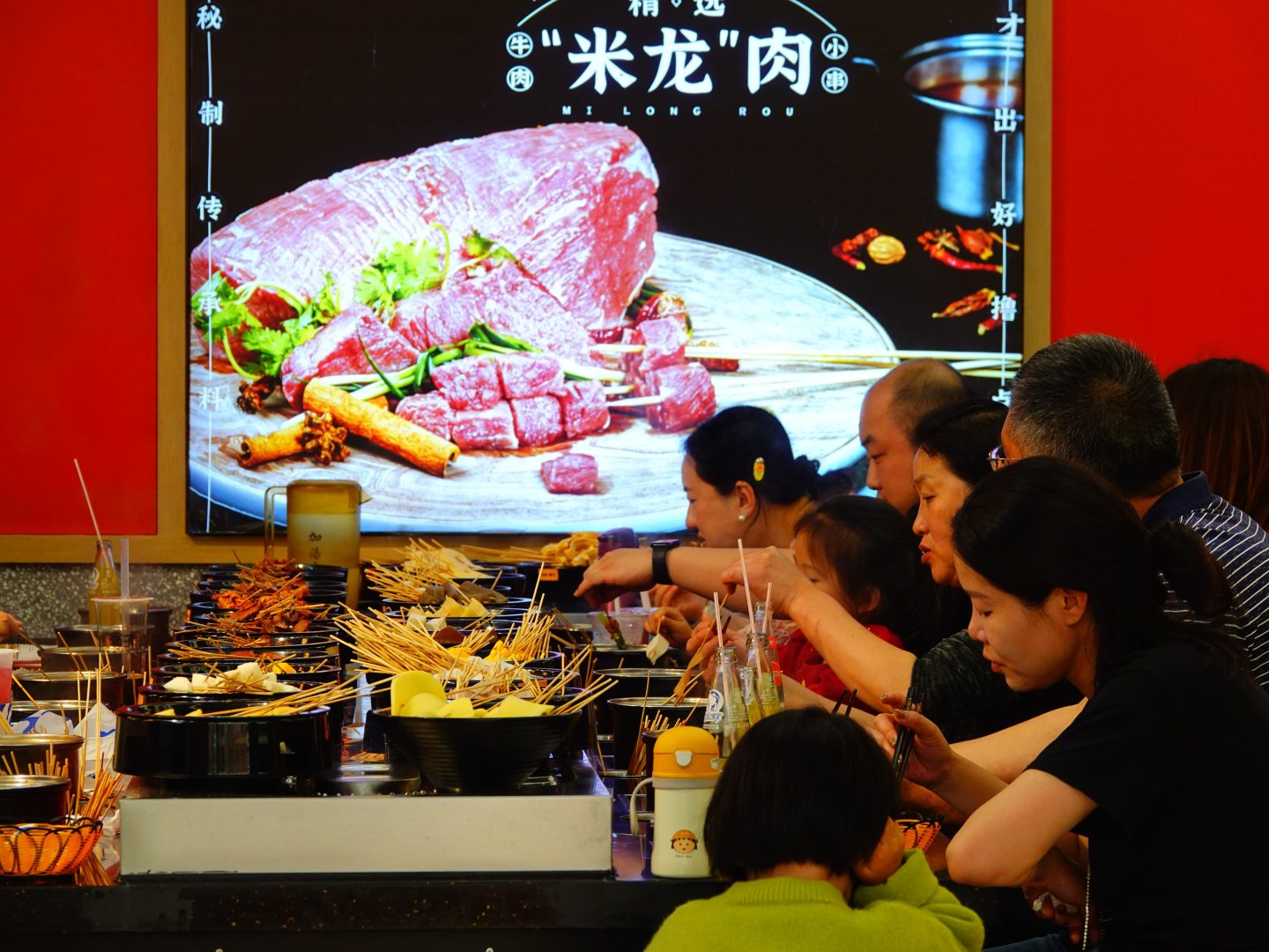 Tourists dine at a restaurant in Wanda Plaza commercial Street during the May Day holiday in Yichang, Hubei province, China, May 5, 2024. 