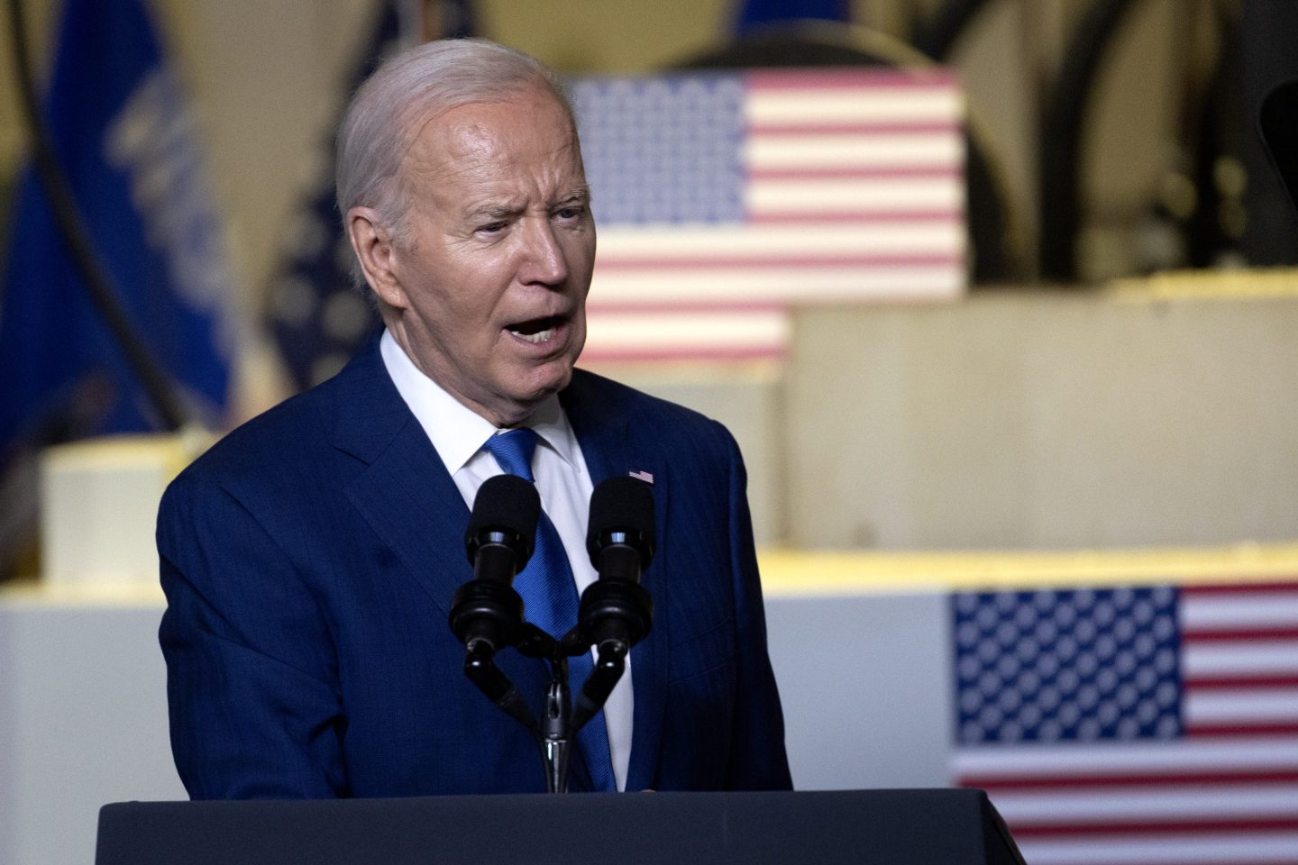 President Joe Biden speaks at podium
