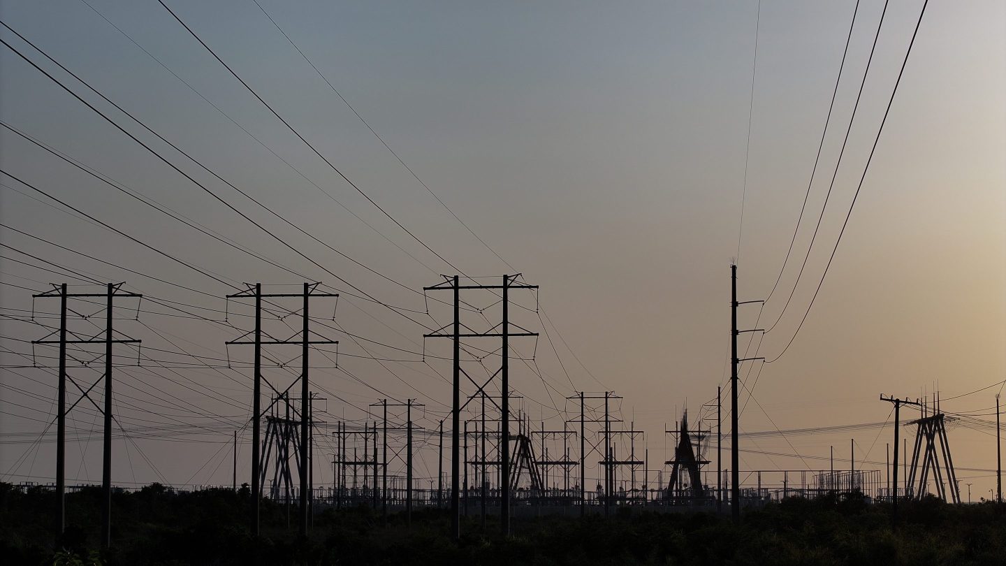Power cables over a field.