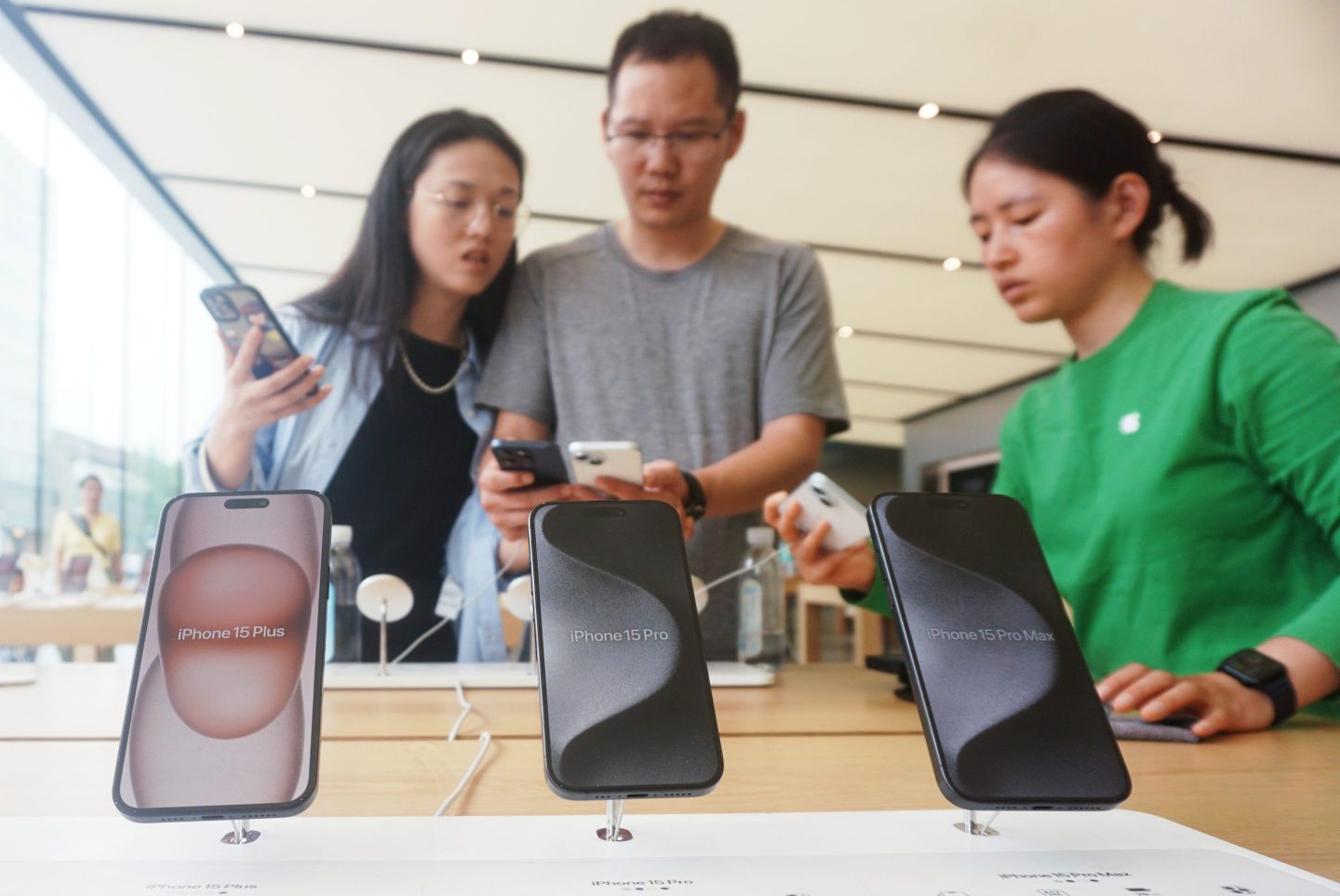 Customers shop for iPhone 15 series at Apple's flagship store in Hangzhou on May 21, 2024