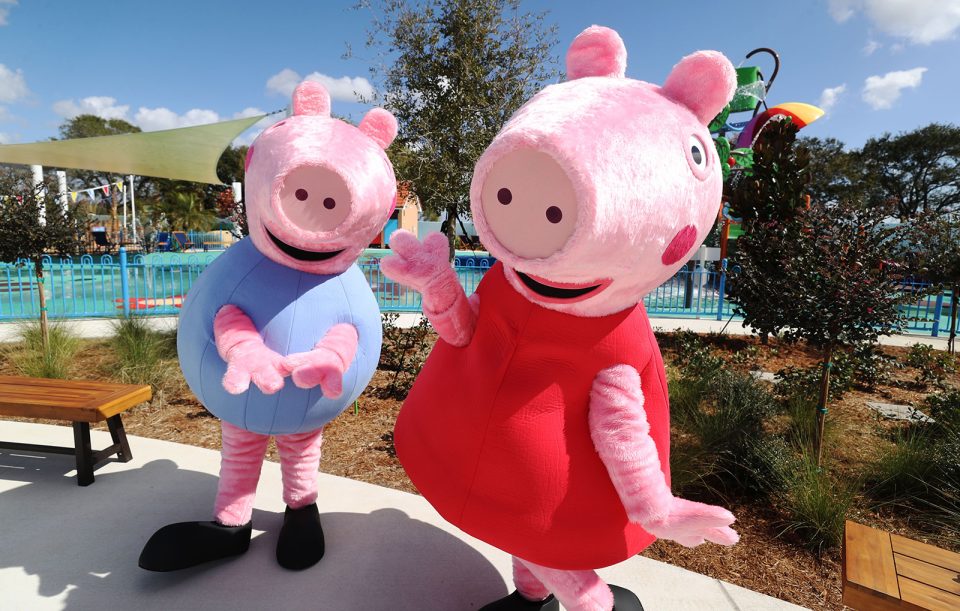 George and Peppa Pig characters pose during the media preview of Peppa Pig Theme Park in Florida