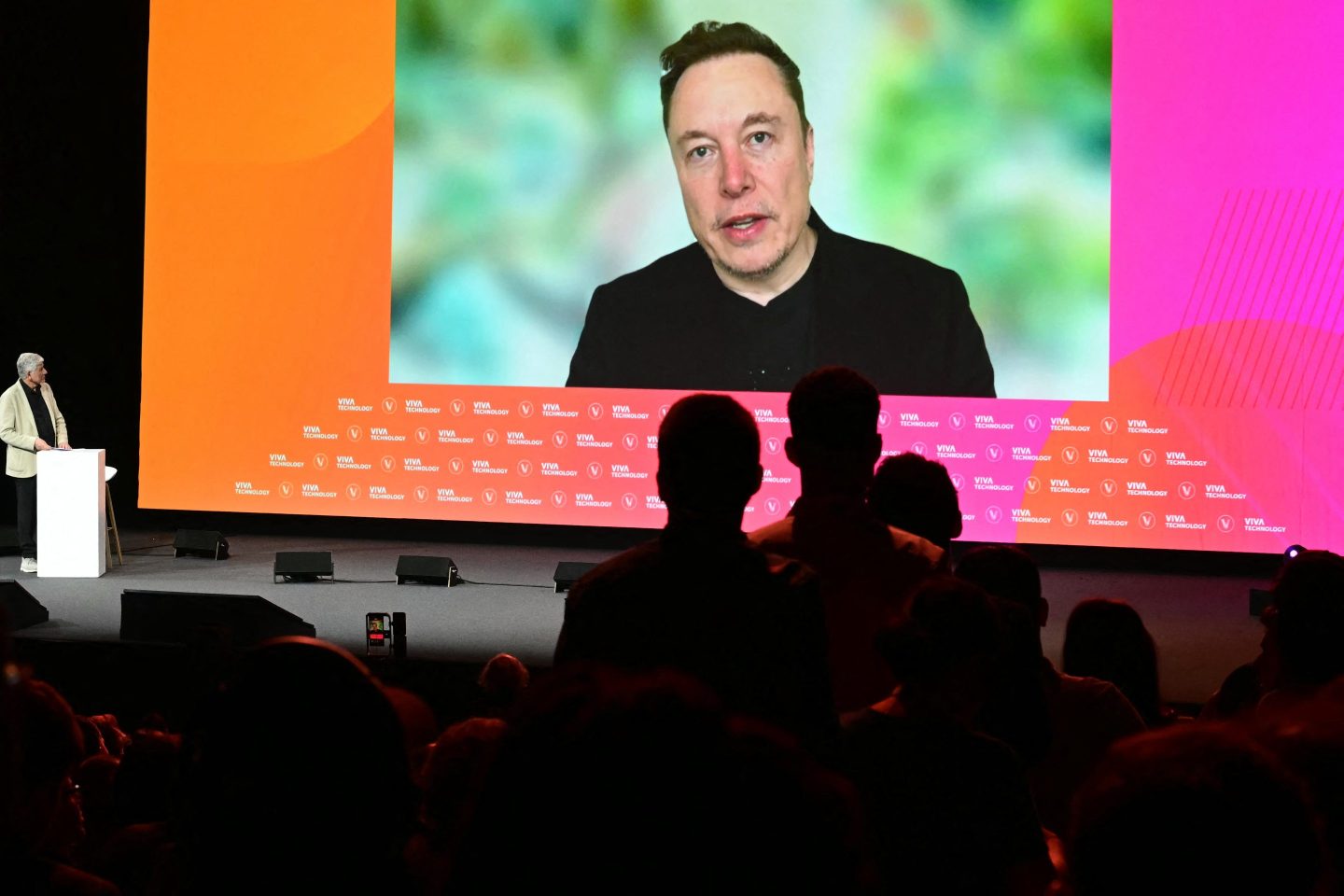 Elon Musk addresses the VivaTech 2024 forum in Paris via video stream, on May 23. Musk revealed that he was surprised by the Biden administration’s new tariff on Chinese EVs.
