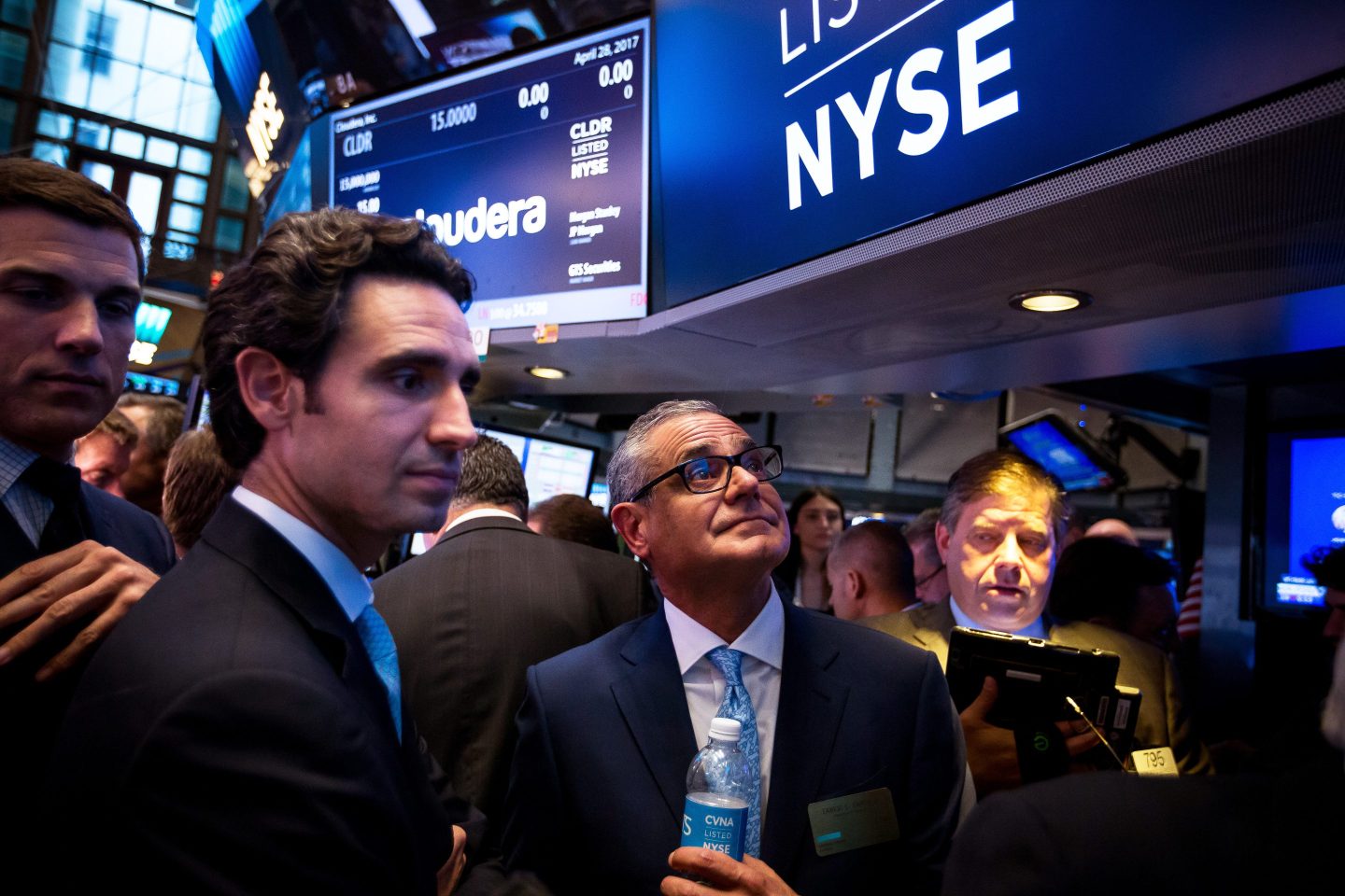 Ernie Garcia III, founder and CEO of Carvana, second left, and his father Ernest Garcia II, chairman, center, stand during the company's IPO on the floor of the New York Stock Exchange on April 28, 2017.