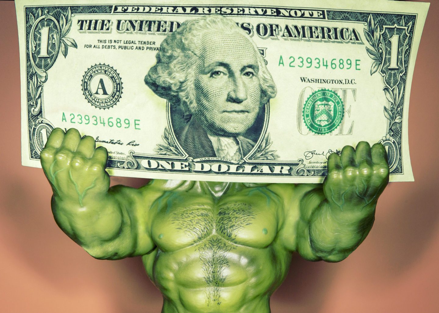 muscular arms hold dollar bill