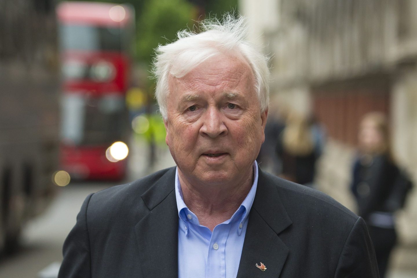 Torstein Hagen is wearing a blue shirt and grey suit.