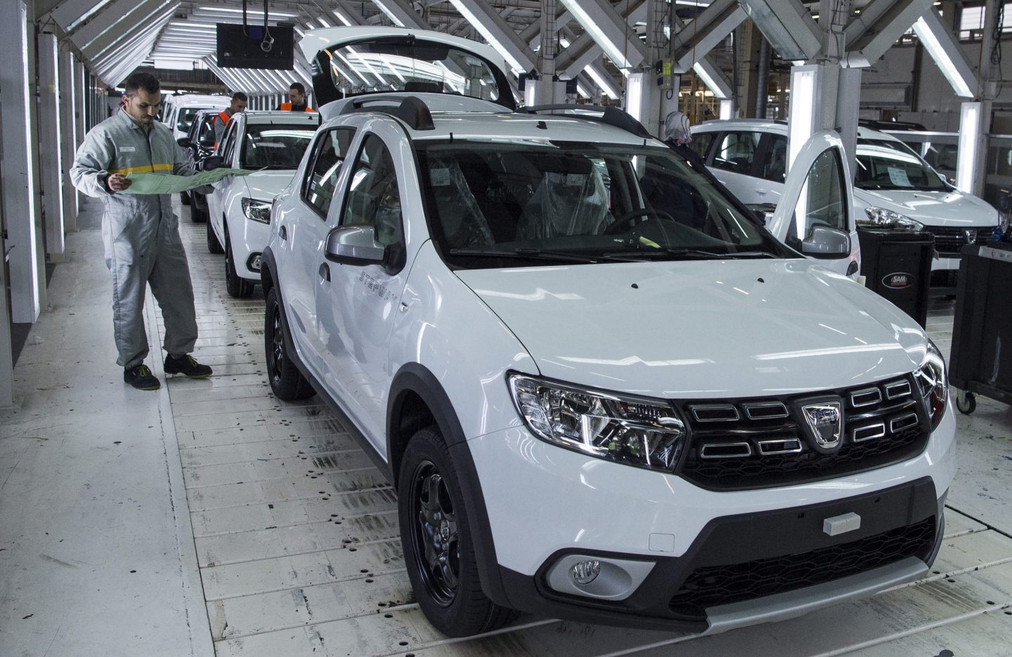 A factory employee works on a car assembly line at the Renault-Nissan Tanger Car Assembly Plant in Melloussa