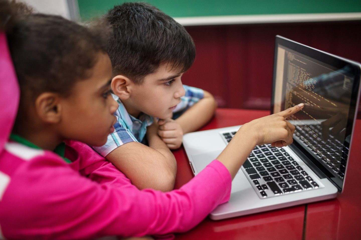 Boy and girl learning coding in school.
