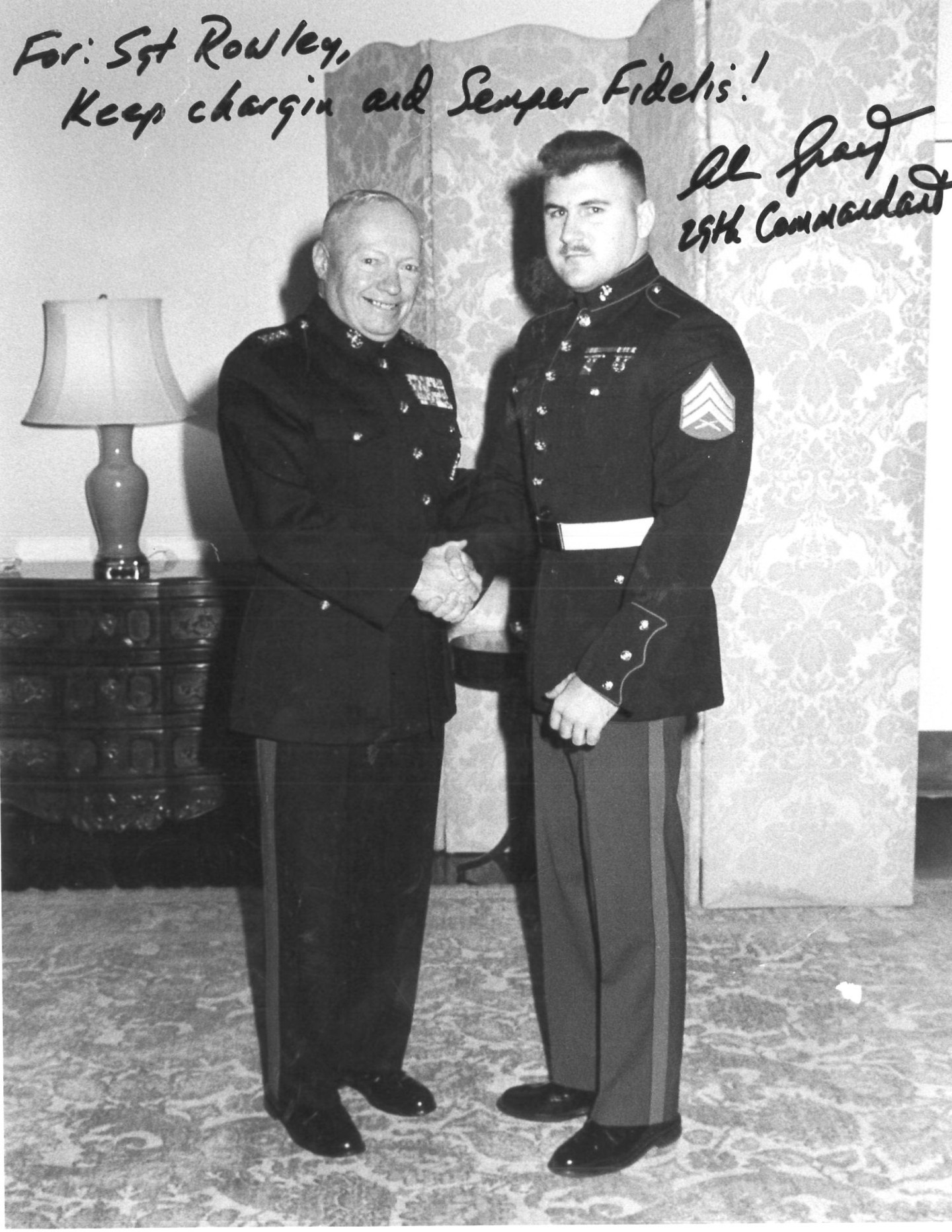 Jim Rowley shakes hands with a military leader