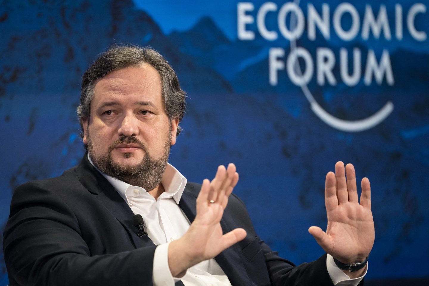Societe Generale CEO Slawomir Krupa gestures with two hands outstretched as he attends a session at the World Economic Forum (WEF) meeting in Davos