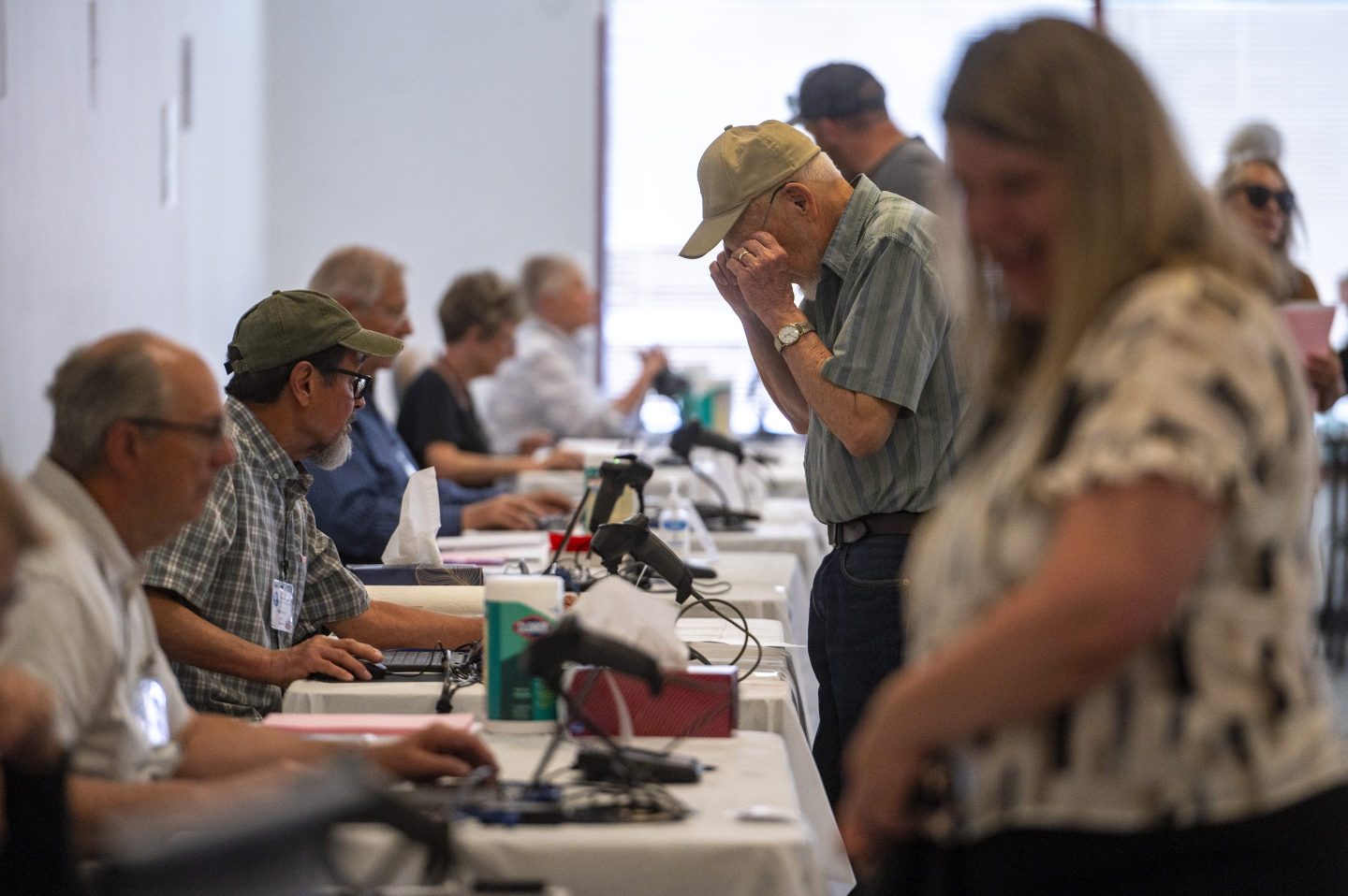 Poll workers help voters at an election center at the Holly Plaza Shopping Center in Albuquerque, N.M., on June 4, 2024.