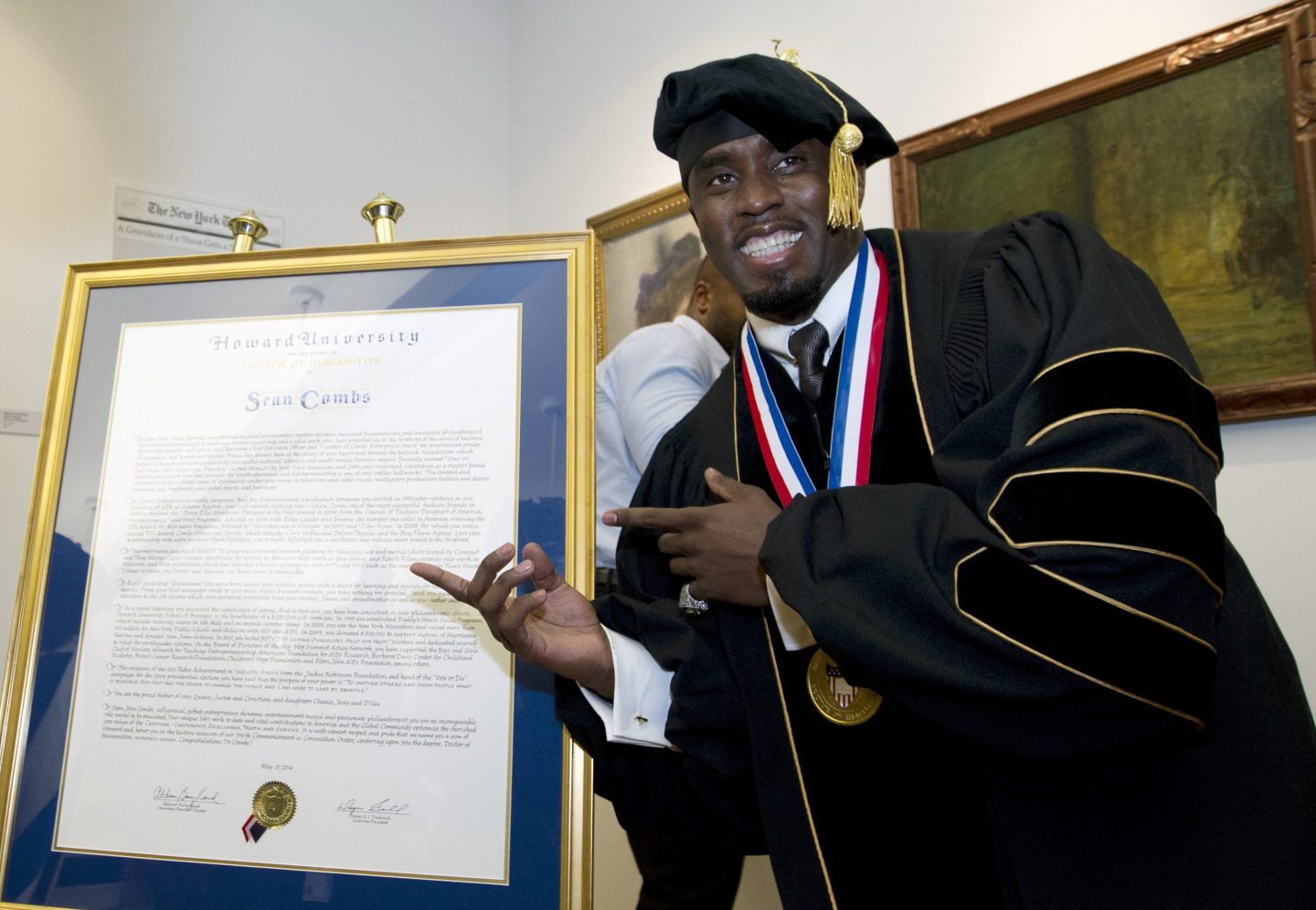 Sean Combs poses next to his honorary degree