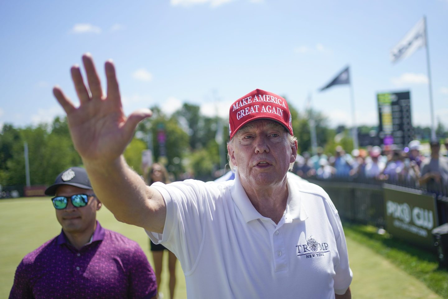 Donald Trump waves while at golf course