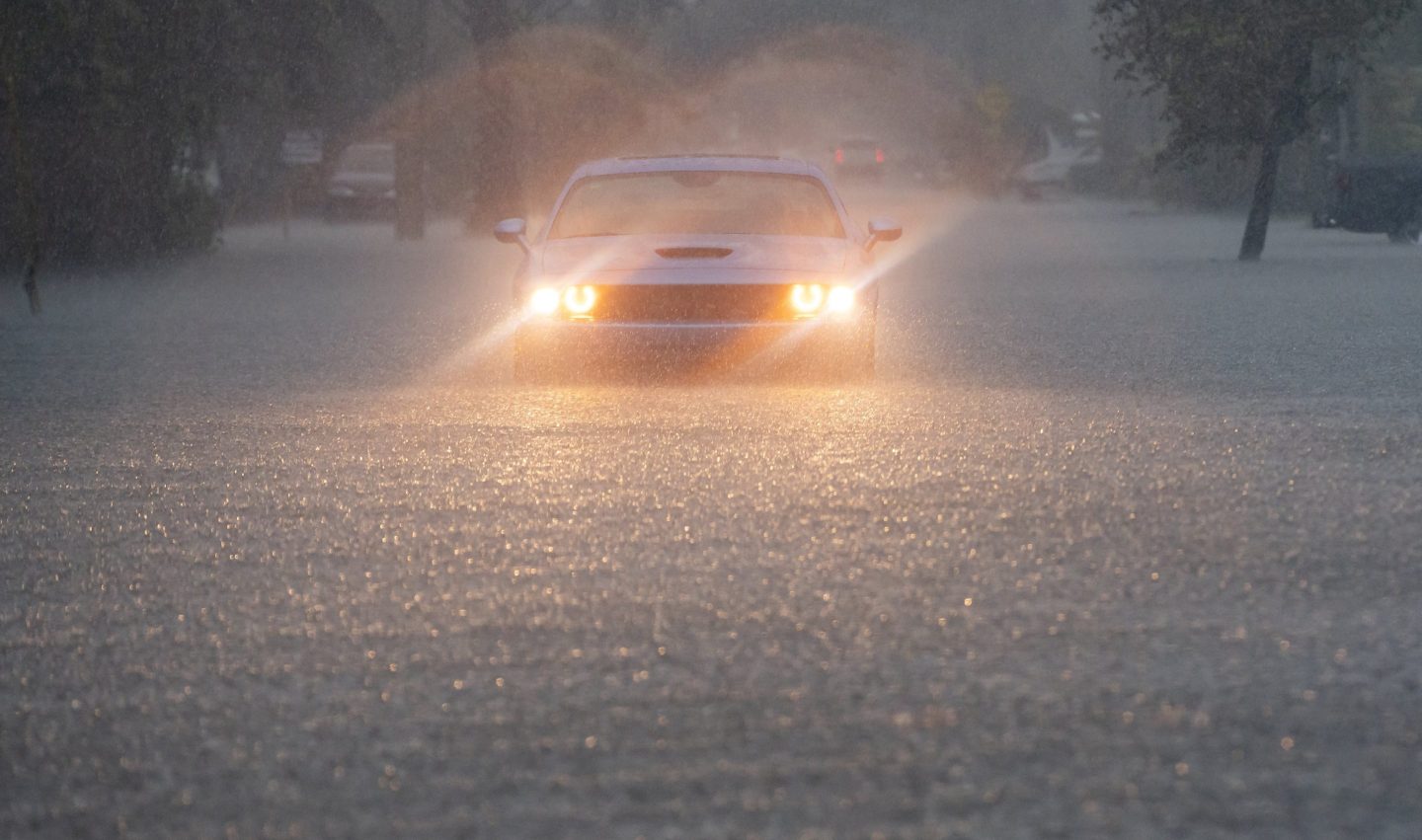 car drives through heavy rain