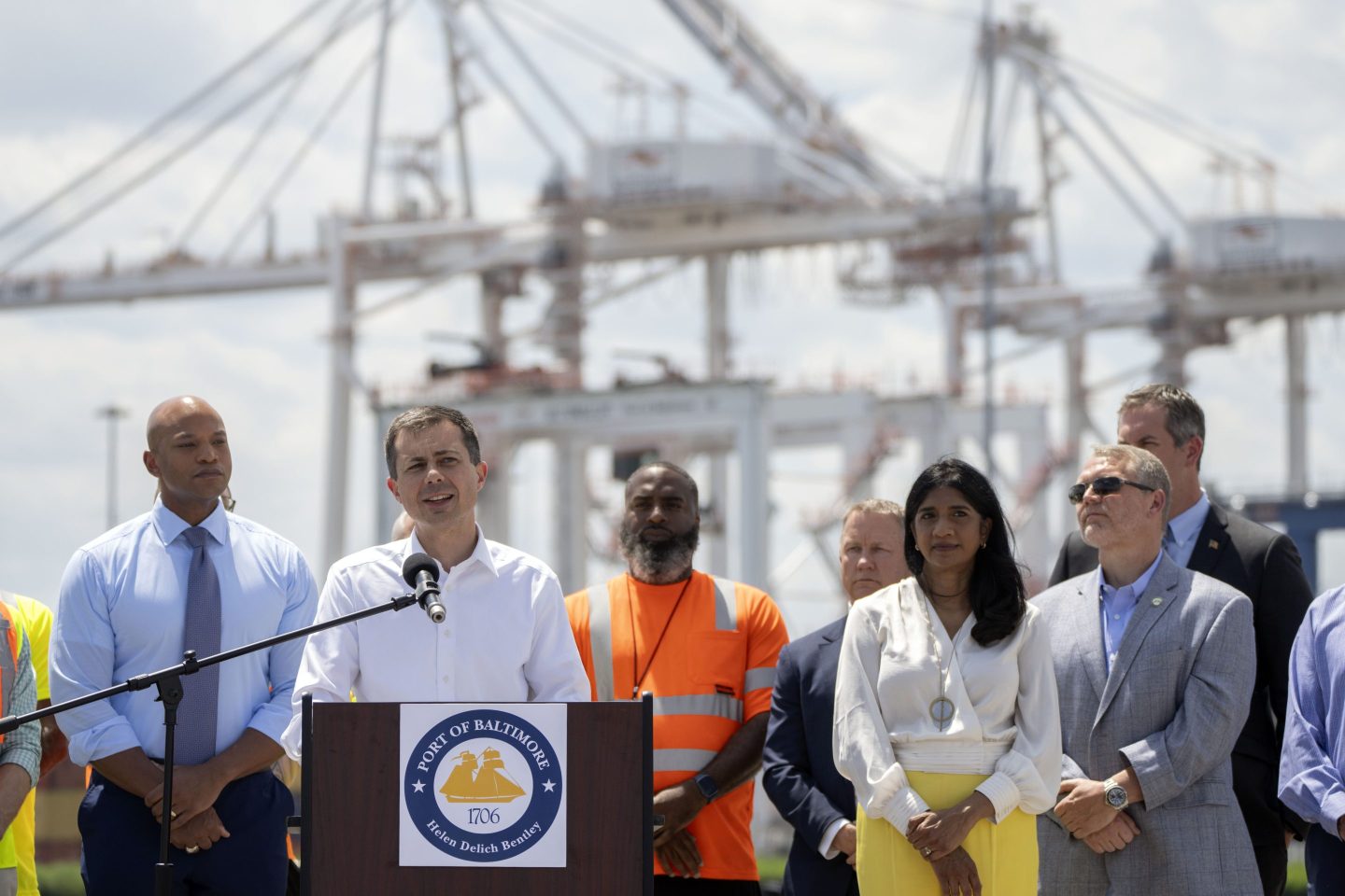 Transportation Secretary Pete Buttigieg, second from left, speaks during a press conference to mark the full reopening of the Port of Baltimore after the collapse of the Francis Scott Key Bridge in March, on June 12, 2024, at the Port of Baltimore in Dundalk, Md.