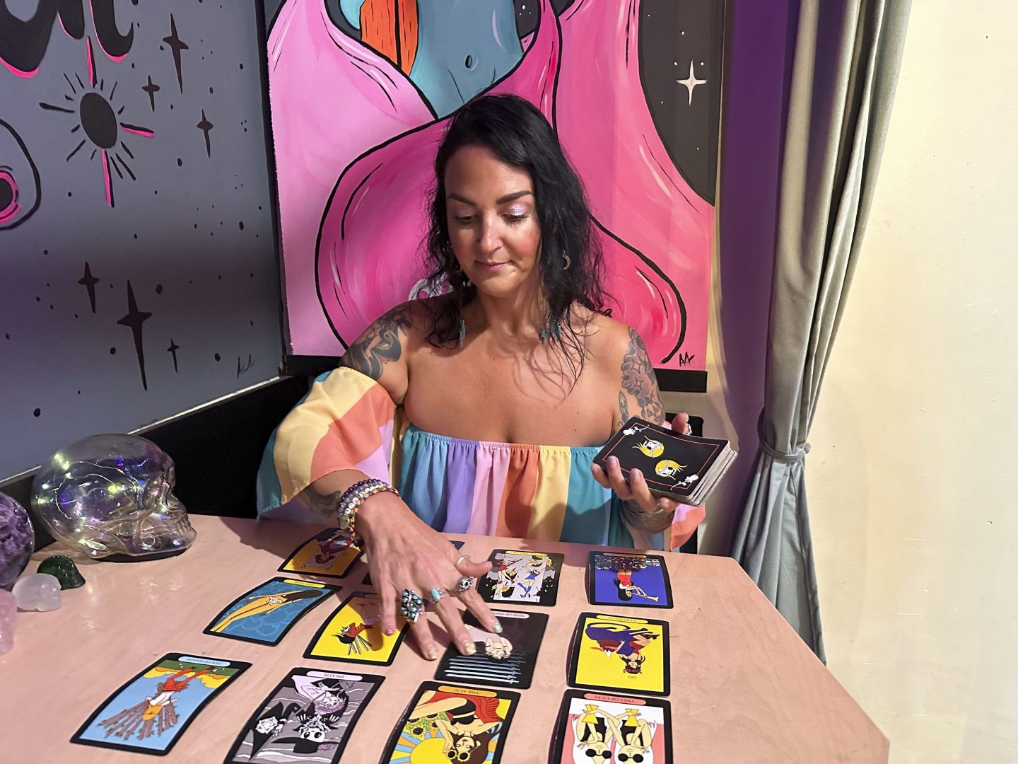 woman lays out tarot cards on table
