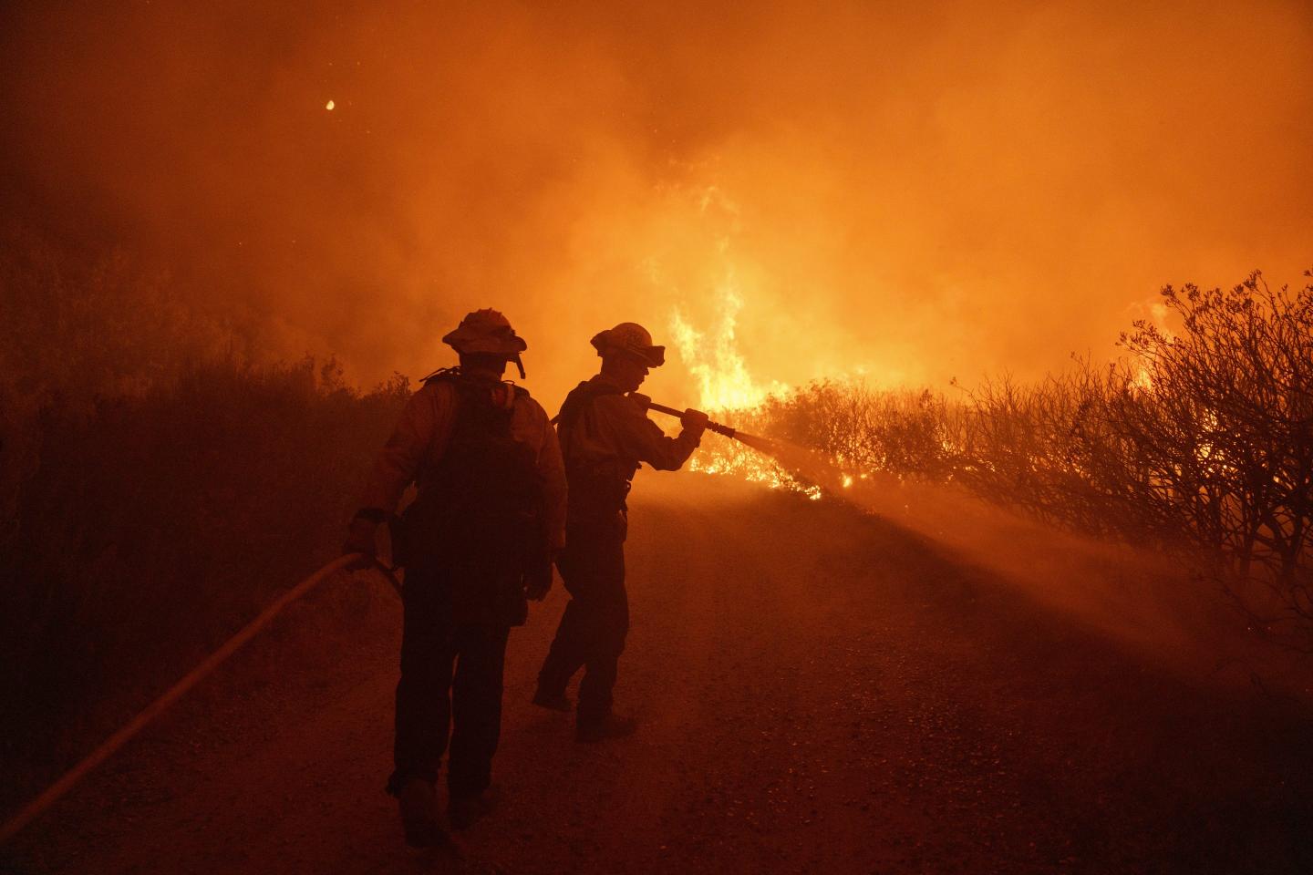 Firefighters work against the advancing Post Fire on Sunday, June 16, 2024, in Gorman, Calif.