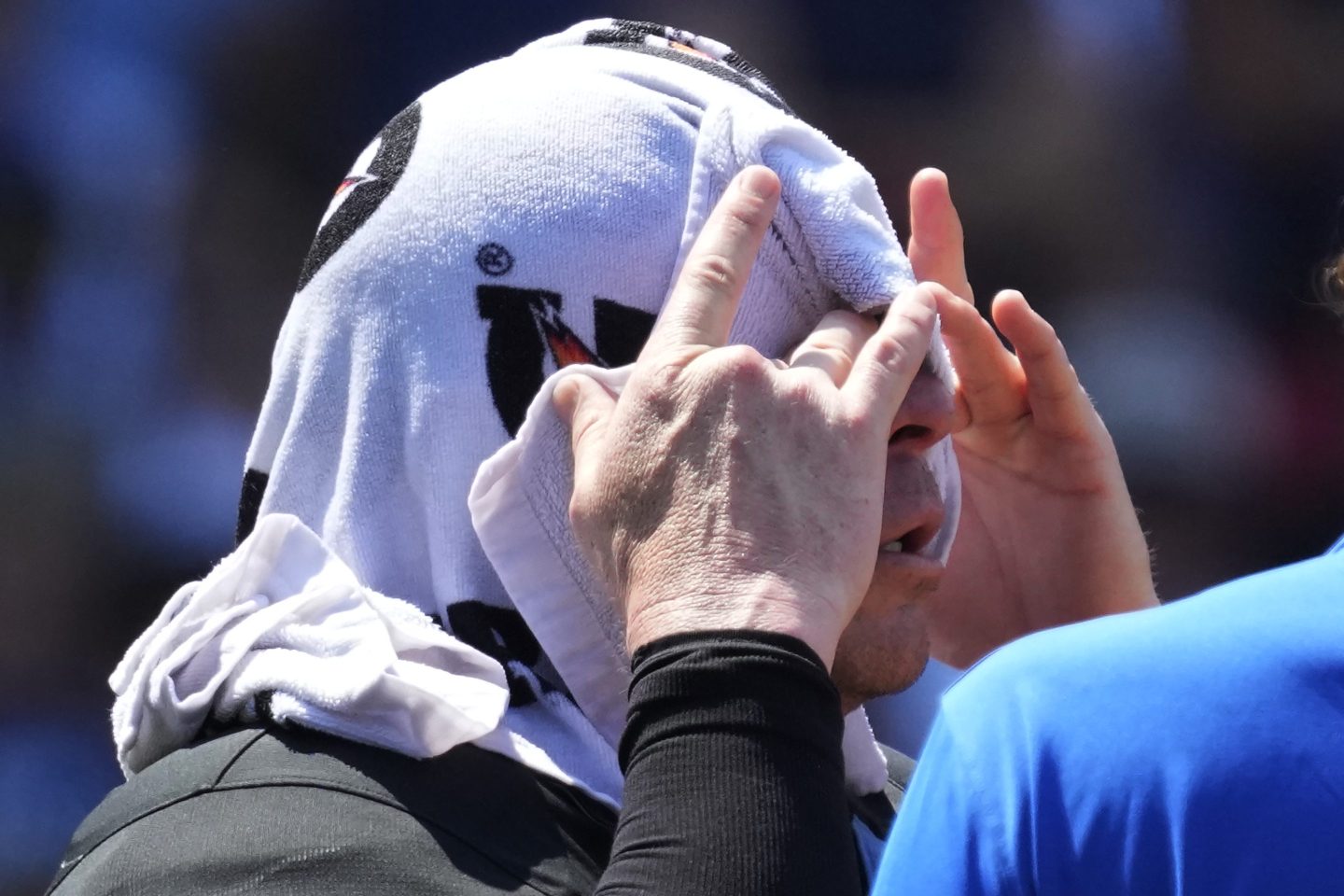 Home plate umpire Carlos Torres cools off during the ninth inning of a baseball game between the St. Louis Cardinals and the Chicago Cubs in Chicago, on June 16, 2024.