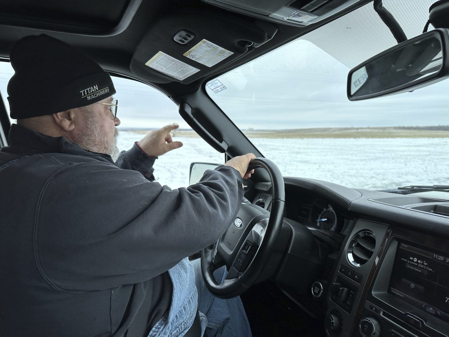 Dan McLean, shown on March 6, 2024, points to where Summit Carbon Solutions' proposed carbon dioxide pipeline would cross his land near Menoken, N.D.