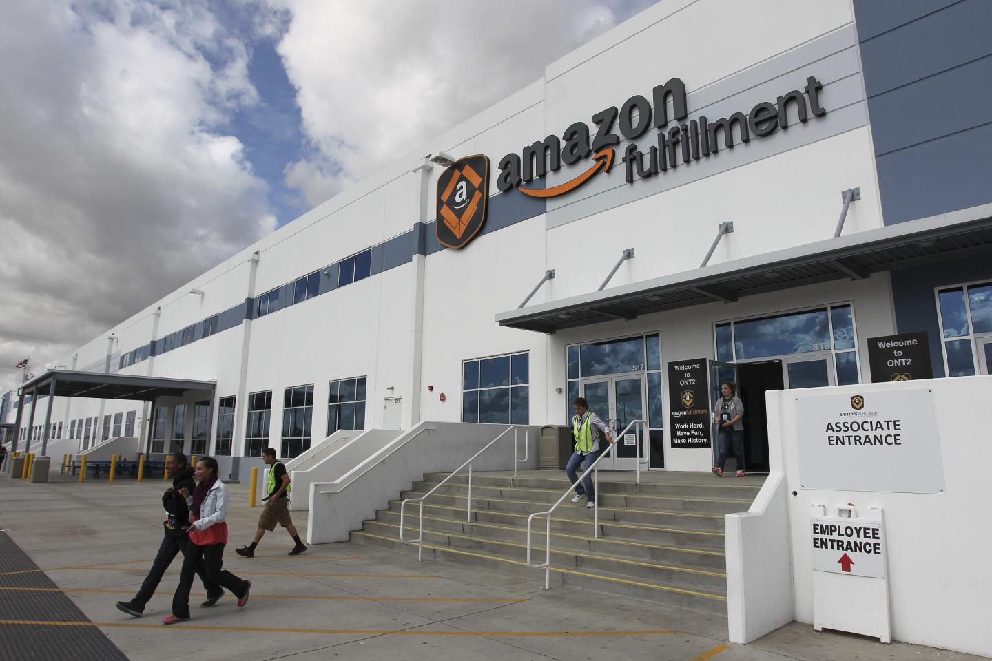 People leave the entrance to the Amazon San Bernardino Fulfillment Center, on Oct. 29, 2013 in San Bernardino, Calif.