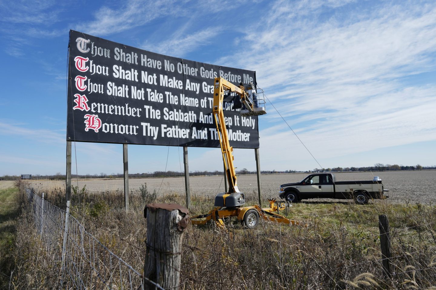 Workers repaint a Ten Commandments billboard off of Interstate 71 on Election Day near Chenoweth, Ohio, Tuesday, Nov. 7, 2023.