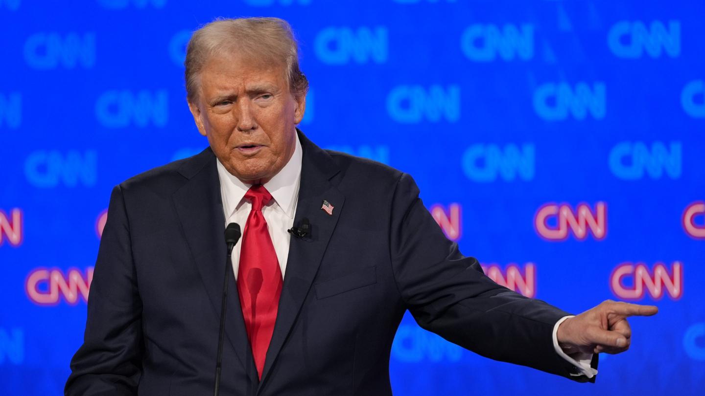 Donald Trump points to his left onstage at the presidential debate hosted by CNN.