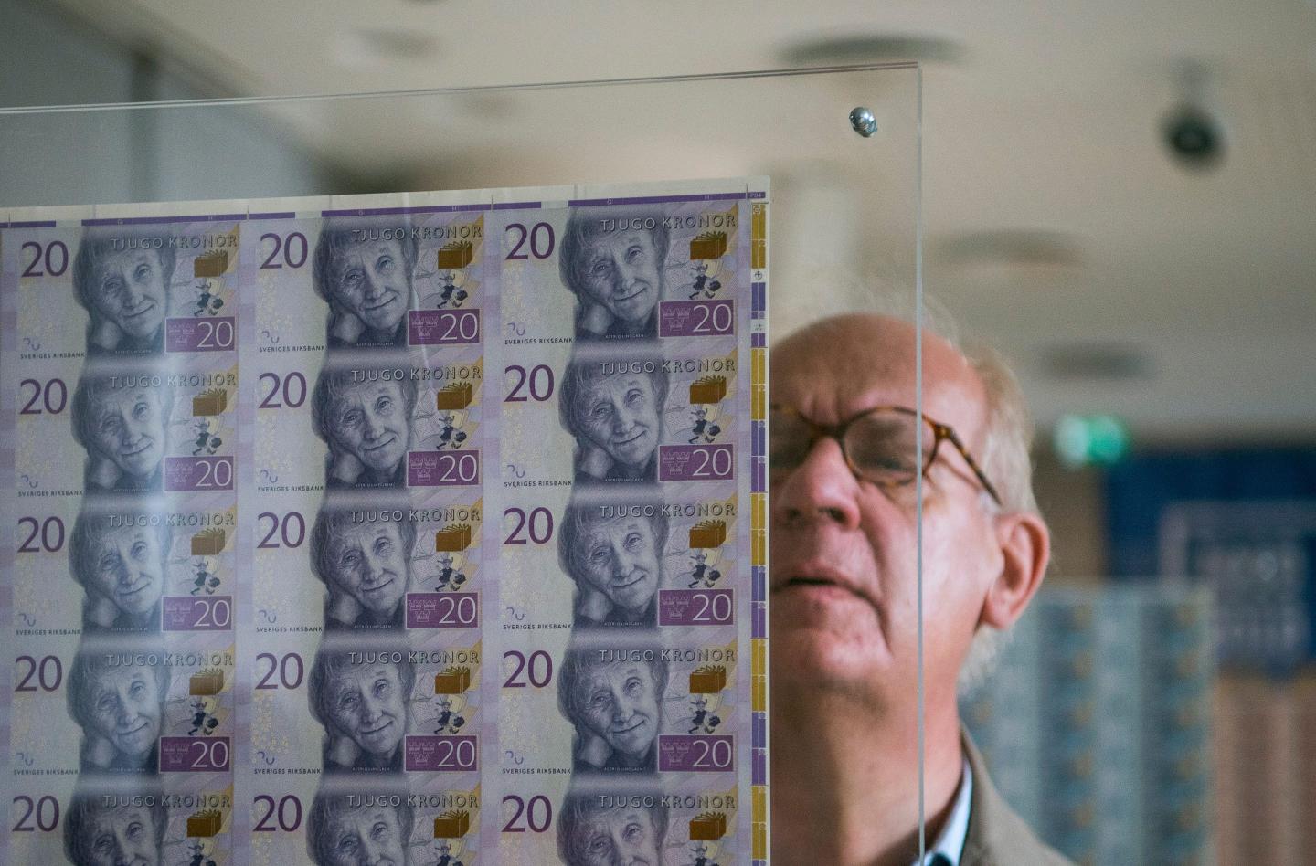 People visit an exhibition containing private banknotes in Sweden.