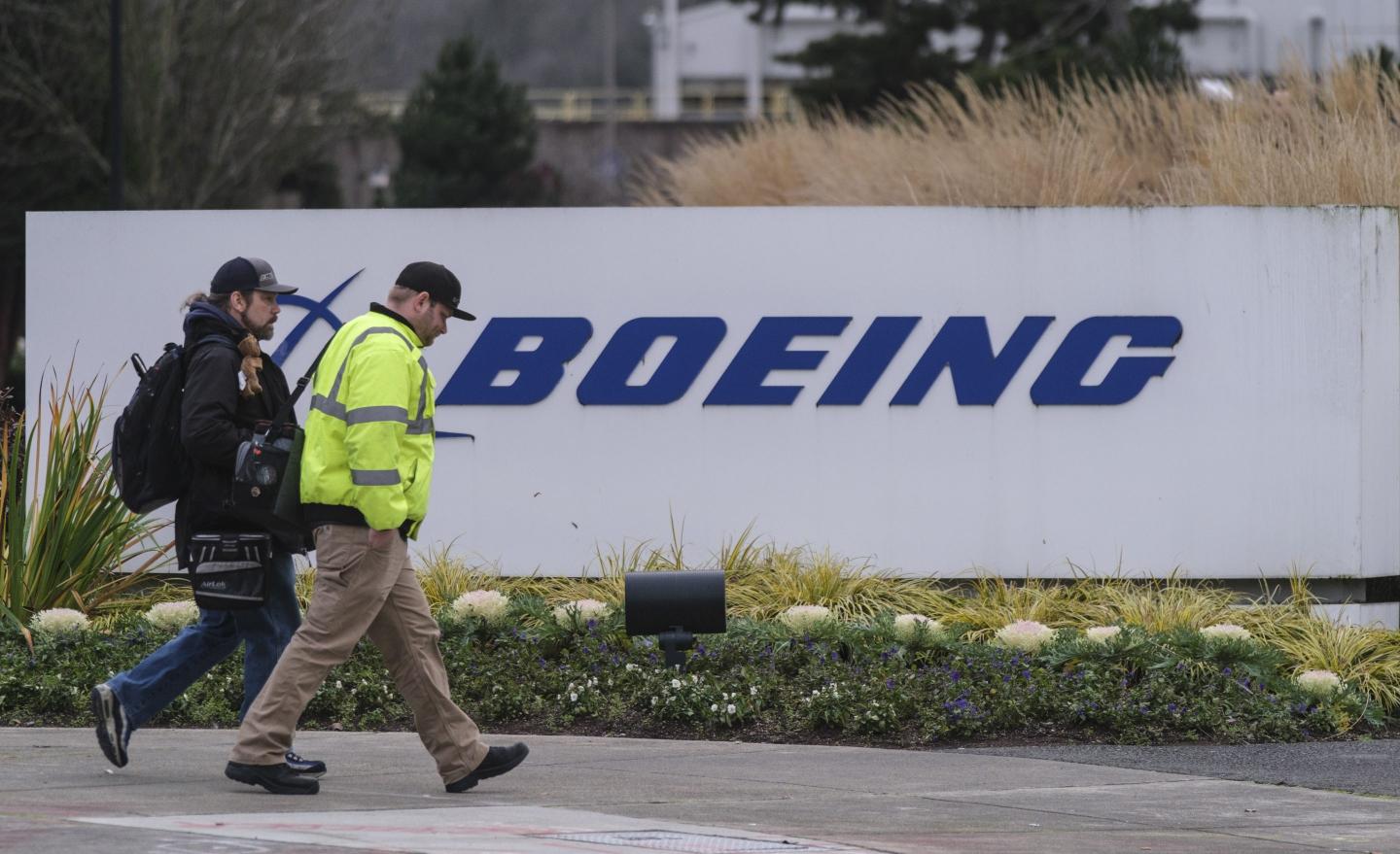 Pair walks past a Boeing sign in Renton, Washington.