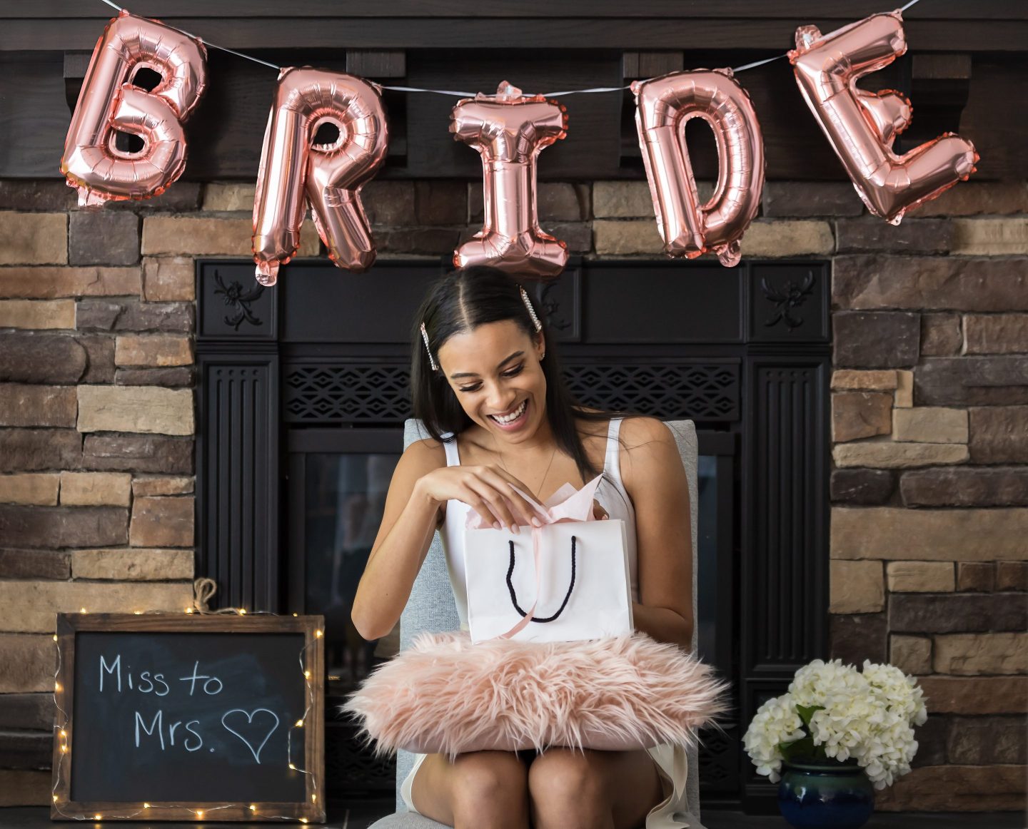 A young woman opening a gift at her bridal shower