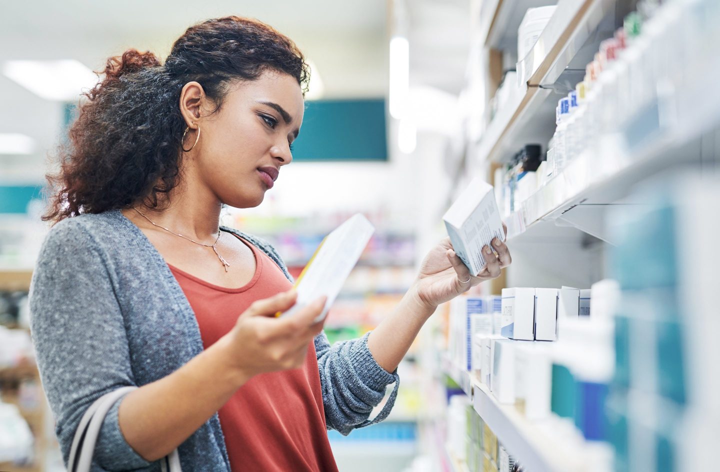 Woman in shopping aisle deciding between two products