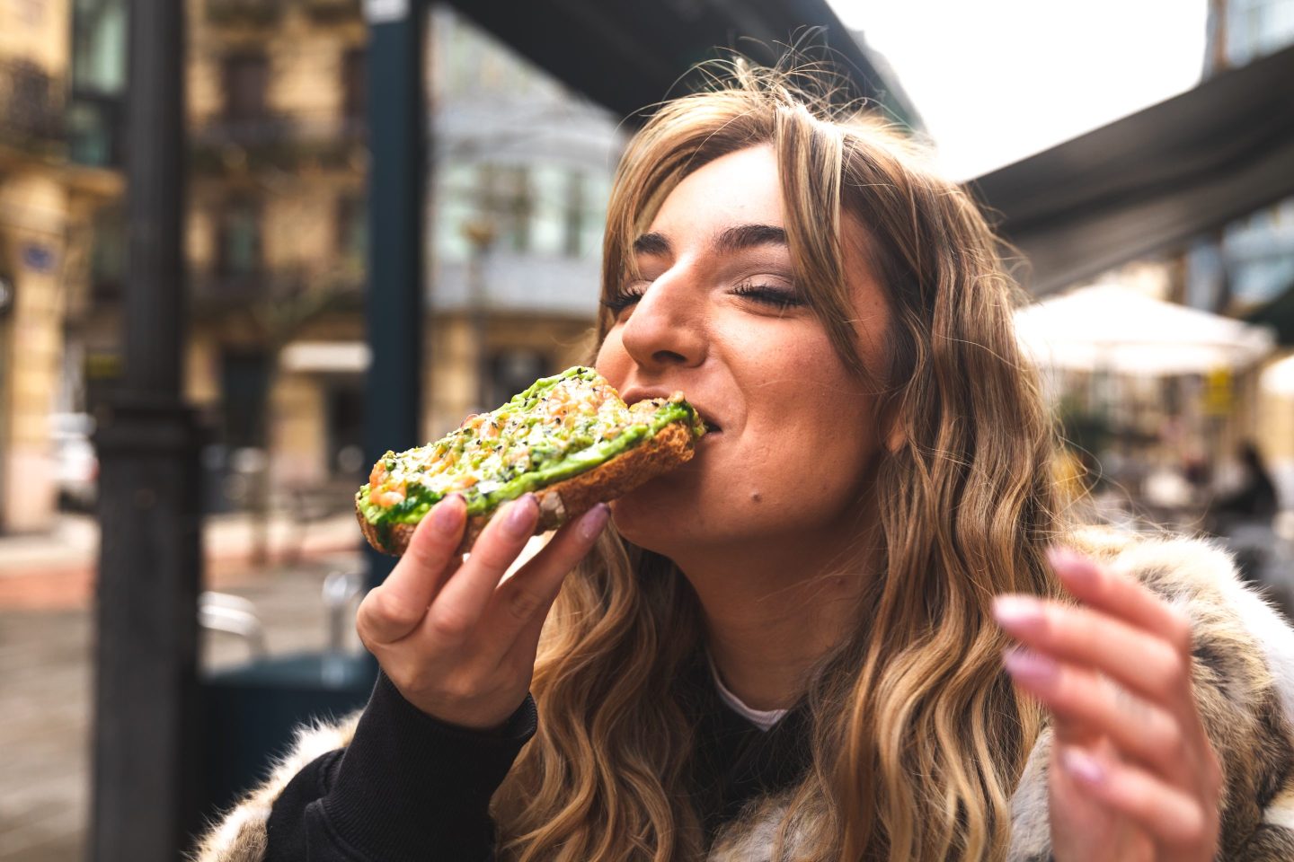 A woman eating avocado toast