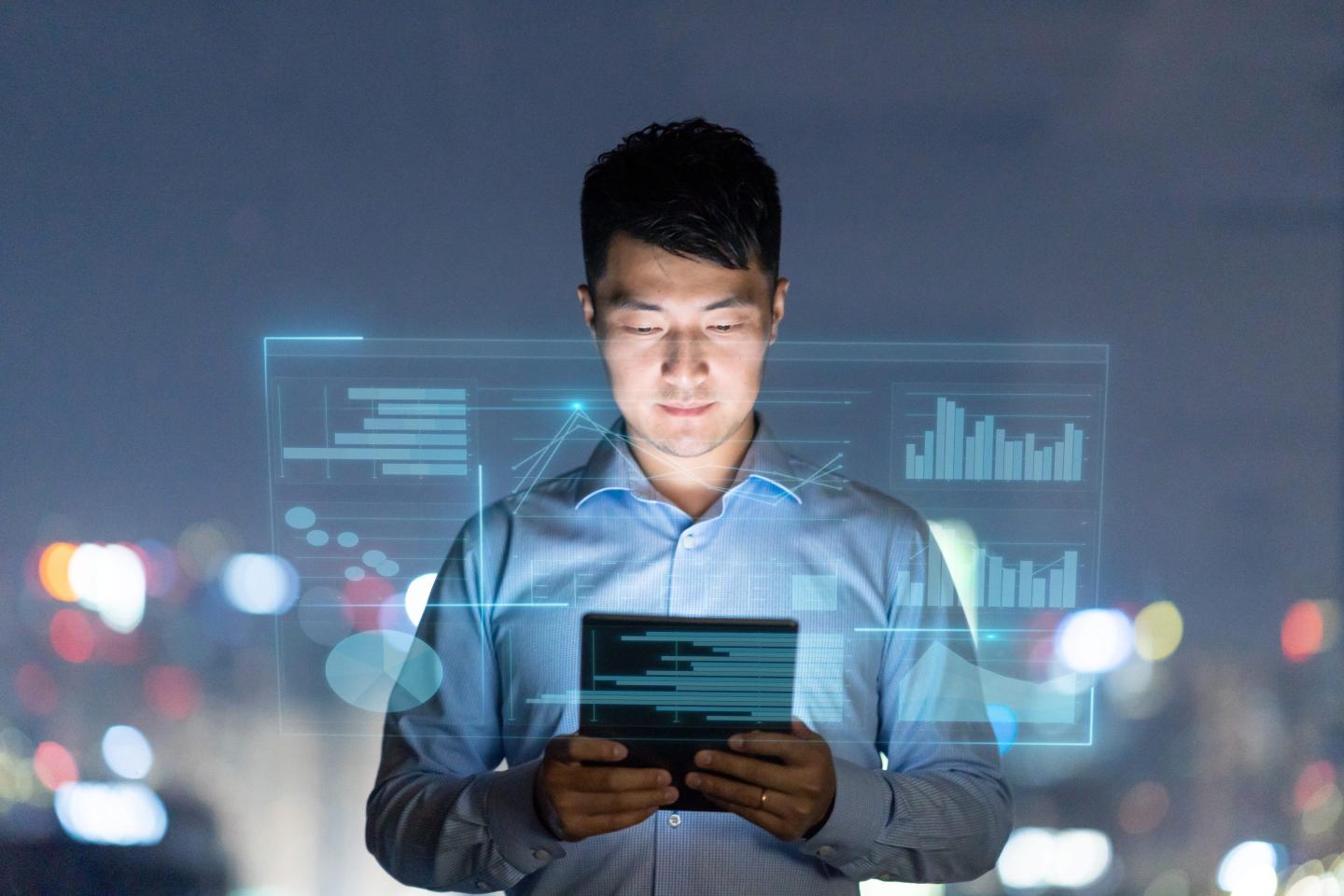 Young man using digital tablet with smart virtual reality screen