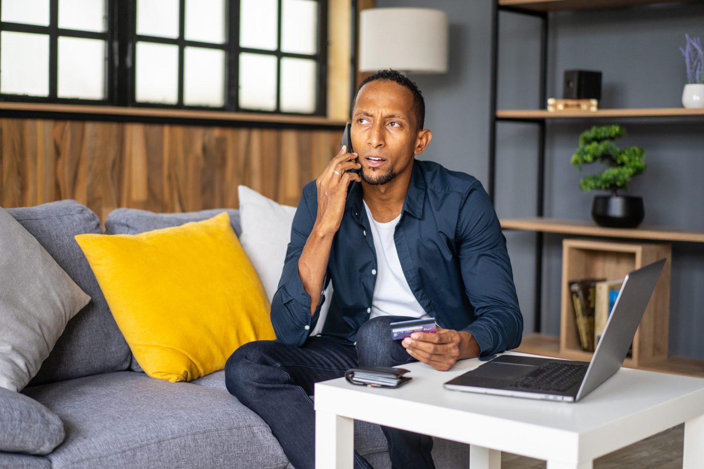 Black man on phone with credit card company
